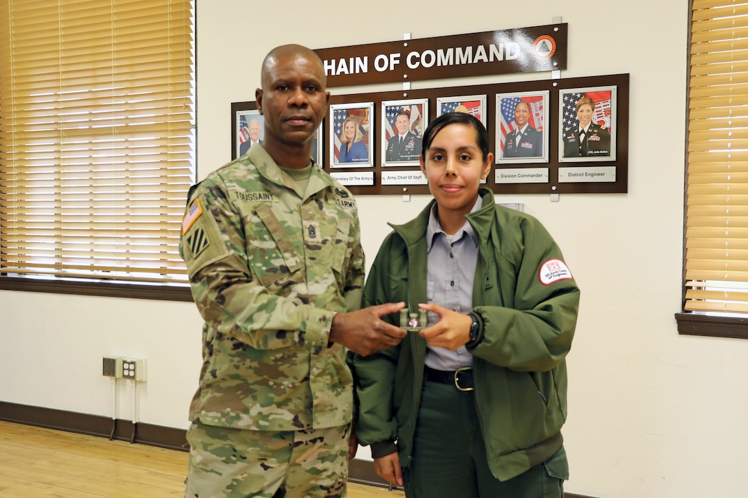 Command Sgt. Maj. Patrickson Toussaint, the U.S. Army Corps of Engineers command sergeant major, presents a coin for excellence to Los Angeles District Park Ranger Annel Monsalvo during a March 29 visit to the District’s baseyard facility in South El Monte, California. Monsalvo was recognized for her efforts engaging Los Angeles  community organizations that led to enhanced relationships at Sepulveda Dam. As the field agents of the Corps’ recreation program, USACE park rangers have two primary responsibilities: promoting and protecting public safety, and practicing good stewardship of the public lands in their care. Those two responsibilities take place on public lands that receive more than 370 million visits a year.