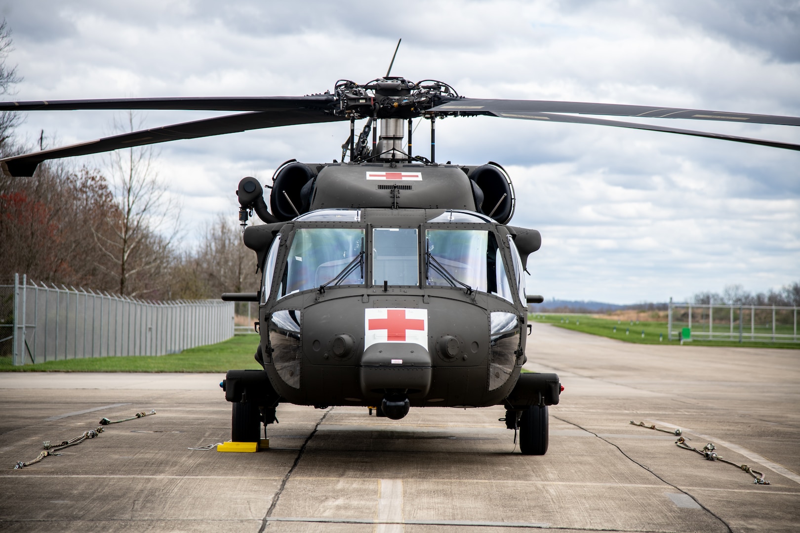 Black Hawk helicopter external shot, sitting on asphalt air strip.