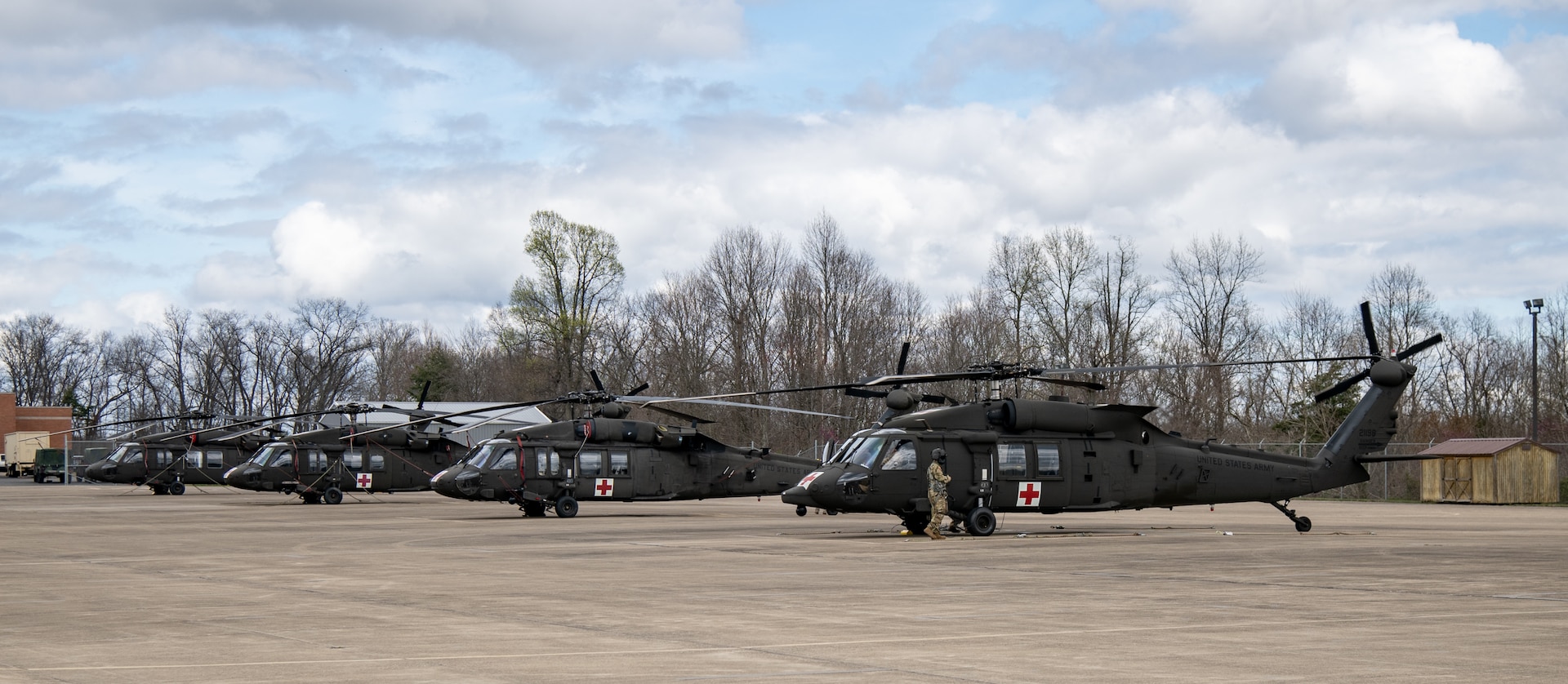 Black Hawk helicopter external shot, sitting on asphalt air strip.