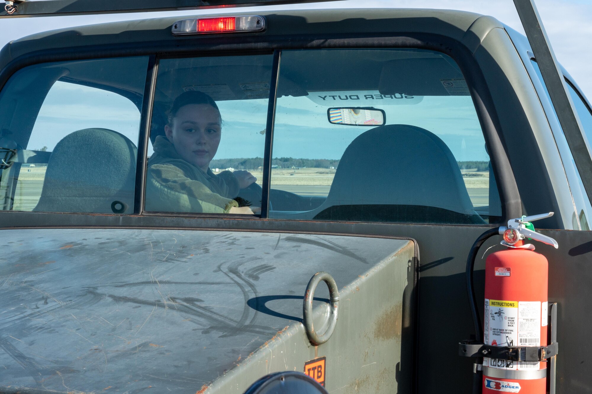 Senior Airman Tess Dickey, a 934th Maintenance Squadron aerospace ground equipment specialist, reverses a government vehicle on the flightline during an exercise at Volk Field Air National Guard Base, Wis., April 6, 2022. The exercise involves a week-long training with the 934th personnel to maintain and display readiness. (U.S. Air Force photo by Staff Sgt. Timothy Leddick)