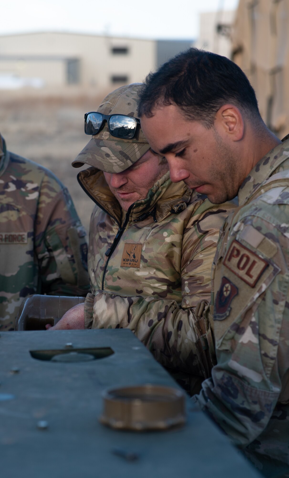 U.S. Air Force Senior Airman Adriel Santaliz-Alvarez, 27th Special Operations Logistics Readiness Squadron petroleum, oils and lubricants journeyman, helps Staff Sgt. Tyler Kochlany, 27th Special Operations Civil Engineer Squadron explosive ordnance disposal technician, fill a generator with fuel during Full Mission Profile 22-3 exercise at Sierra Blanca Regional Airport, New Mexico. (U.S. Air Force photo by Senior Airman Christopher Storer)