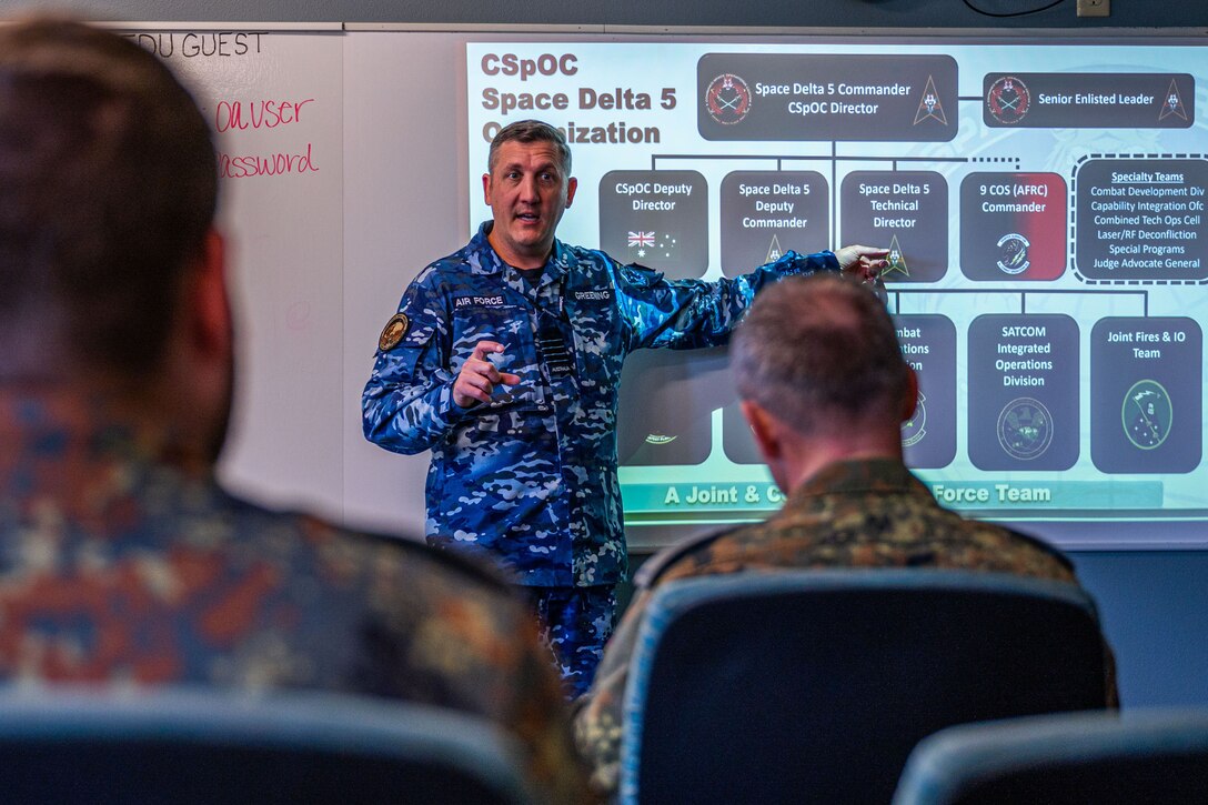 Military member conducting a mission briefing slideshow