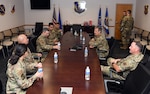 Maj. Gen. Bryan P. Radliff, 10th Air Force commander (center-right), and Chief Master Sgt. Jeremy N. Malcolm, 10th AF command chief (right), meet with 960th Cyberspace Wing Airmen to discuss successes and concerns April 2, 2022, at Joint Base San Antonio-Chapman Training Annex, Texas. These meetings provide an opportunity for senior leaders to interact directly with junior unit Airmen. (U.S. Air Force photo by Kristian Carter)