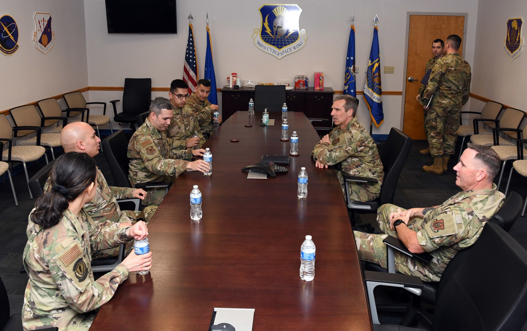 Maj. Gen. Bryan P. Radliff, 10th Air Force commander (center-right), and Chief Master Sgt. Jeremy N. Malcolm, 10th AF command chief (right), meet with 960th Cyberspace Wing Airmen to discuss successes and concerns April 2, 2022, at Joint Base San Antonio-Chapman Training Annex, Texas. These meetings provide an opportunity for senior leaders to interact directly with junior unit Airmen. (U.S. Air Force photo by Kristian Carter)