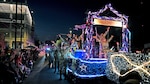 Reserve Citizen Airmen in the 433rd Airlift Wing, 960th Cyberspace Wing, 340th Flying Training Group and 23rd Intelligence Squadron sing along with the crowd during the Flambeau parade in downtown San Antonio, April 9, 2022. This was the first time the four South Texas Reserve units worked together on a float for the annual Fiesta celebration. (U.S. Air Force photo by Master Sgt. Samantha Mathison)