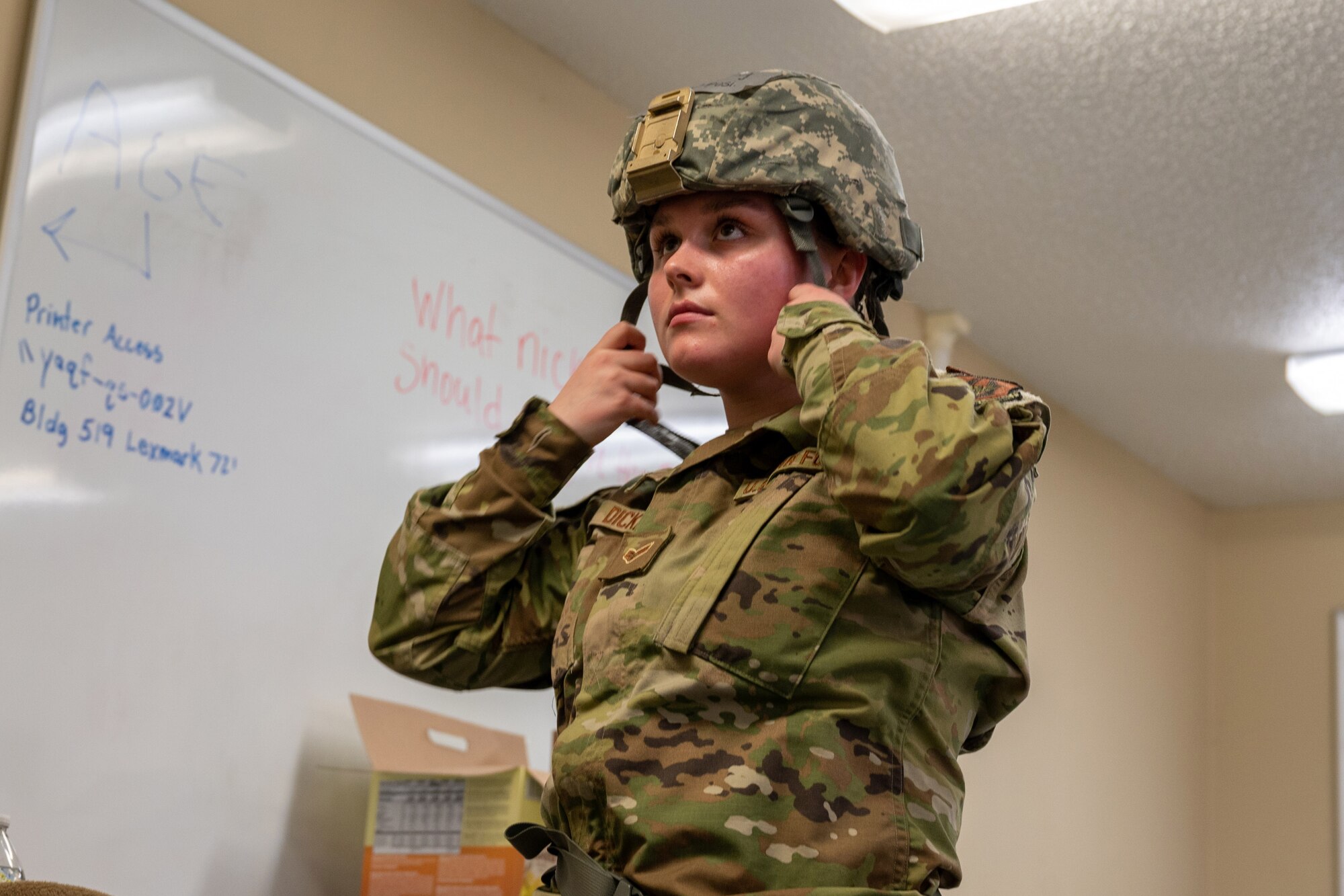 Senior Airman Tess Dickey, a 934th Maintenance Squadron aerospace ground equipment specialist, dons her helmet during an exercise at Volk Field Air National Guard Base, Wis., April 6, 2022. The exercise involves week-long training with the 934th personnel to maintain and display readiness. (U.S. Air Force photo by Staff Sgt. Timothy Leddick)