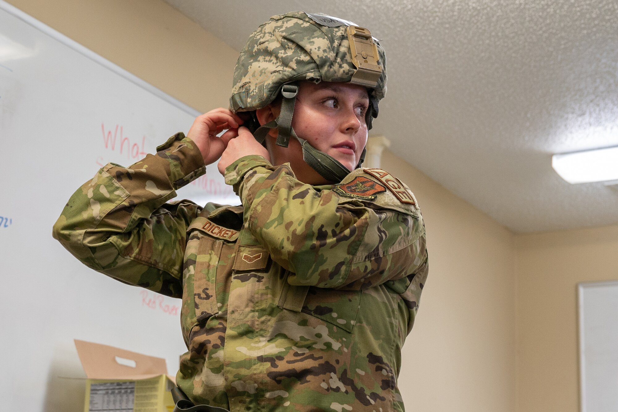 Senior Airman Tess Dickey, a 934th Maintenance Squadron aerospace ground equipment specialist, dons her helmet during an exercise at Volk Field Air National Guard Base, Wis., April 6, 2022. The exercise involves week-long training with the 934th personnel to maintain and display readiness. (U.S. Air Force photo by Staff Sgt. Timothy Leddick)