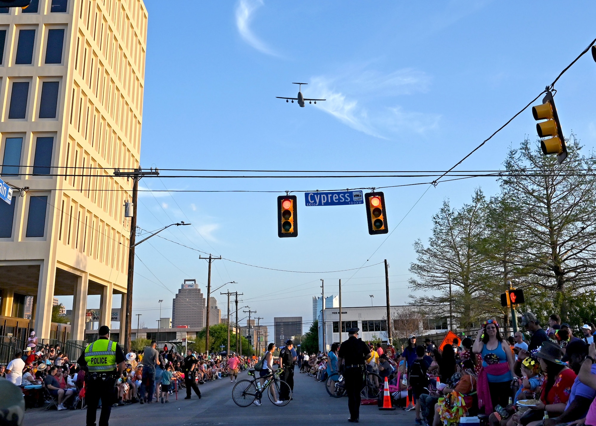 A 433rd Airlift Wing C-5M Super Galaxy aircraft flies over the Flambeau Parade route in downtown San Antonio to celebrate Fiesta, April 9, 2022. The flyover kicked-off the parade, where four South Texas Reserve units collaborated for the first time to enter a float together. (U.S. Air Force photo by Master Sgt. Samantha Mathison)