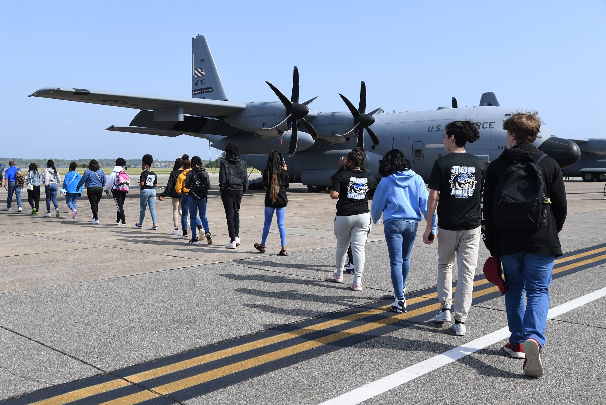Jefferson Davis County High School Junior ROTC cadets walk toward a WC-130J aircraft on a tour at Keesler Air Force Base, Mississippi, April 12, 2022. Throughout their visit to Keesler, more than 30 cadets received a Hurricane Hunters briefing, visited air traffic control training courses and received a military working dog demonstration. (U.S. Air Force photo by Kemberly Groue)