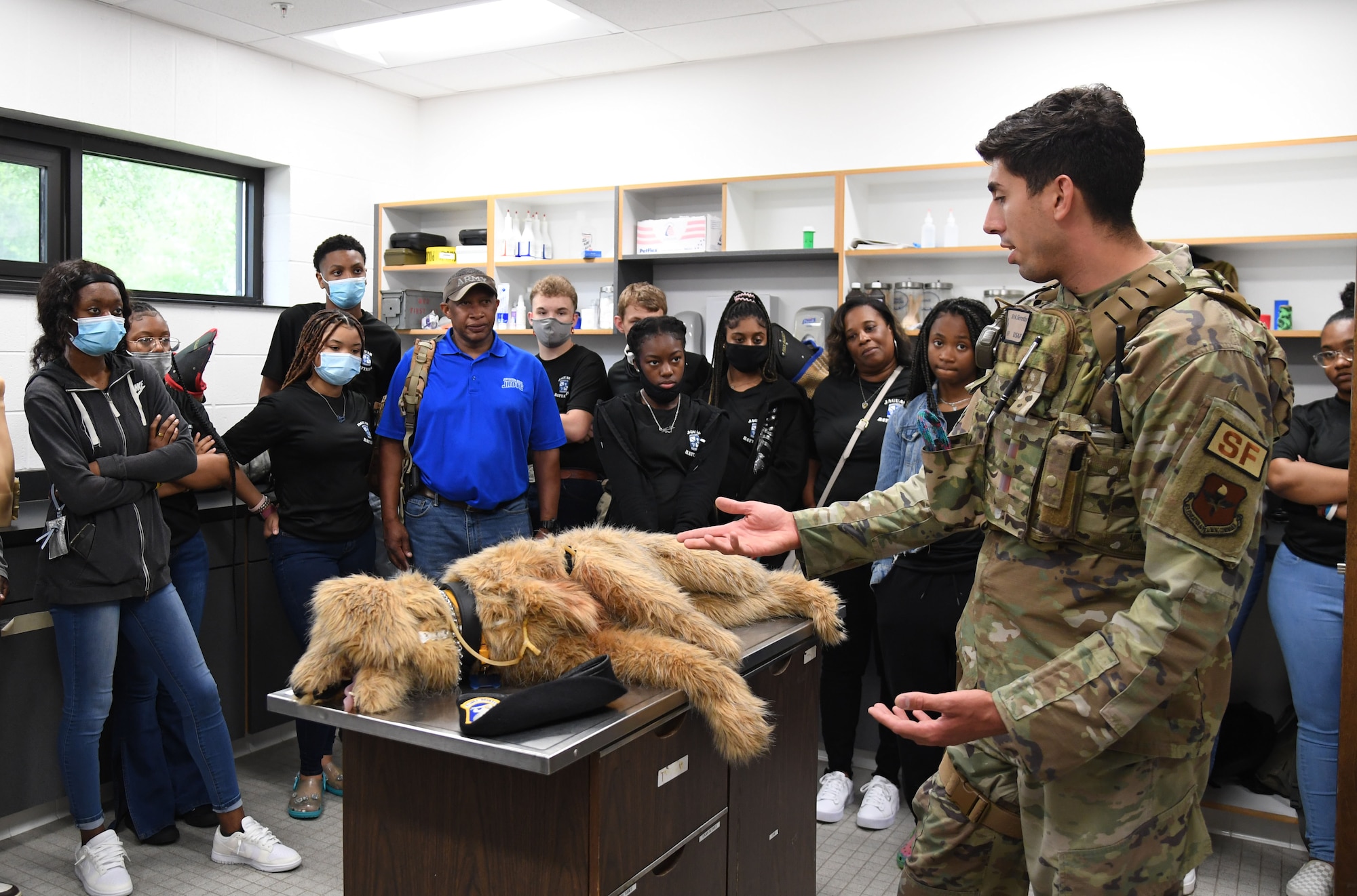 U.S. Air Force Senior Airman Anthony Seretis, 81st Security Forces Squadron military working dog handler, delivers a military working dog brief to Jefferson Davis County High School Junior ROTC cadets inside the kennel at Keesler Air Force Base, Mississippi, April 12, 2022. Throughout their visit to Keesler, more than 30 cadets received a Hurricane Hunters briefing, visited air traffic control training courses and received a military working dog demonstration. (U.S. Air Force photo by Kemberly Groue)