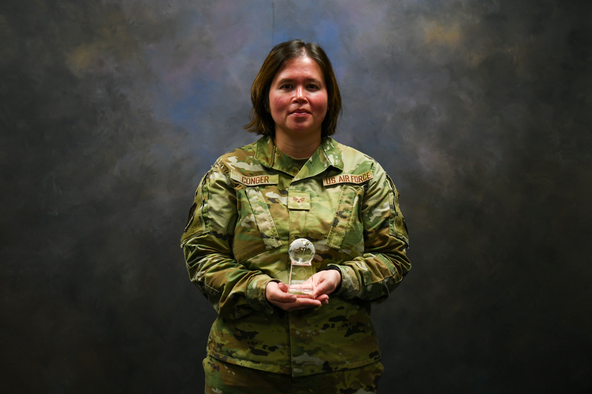 U.S. Air Force Senior Airman Gloria Conger, 97th Air Mobility Wing command post emergency actions controller, poses for a photo at Altus Air Force Base, Oklahoma, April 5, 2022. Conger earned the 2021 Air Education and Training Command Airman of the Year Award. (U.S. Air Force photo by Airman 1st Class Miyah Gray)