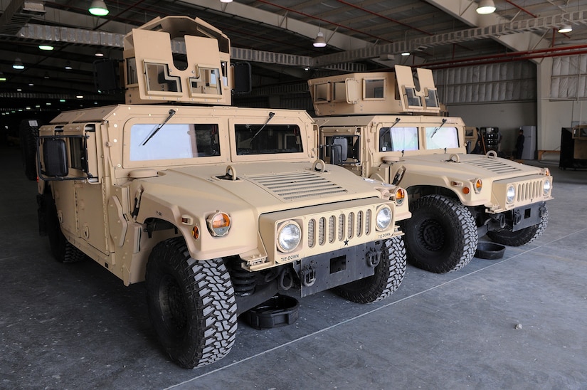 A combat vehicle sits in a garage.