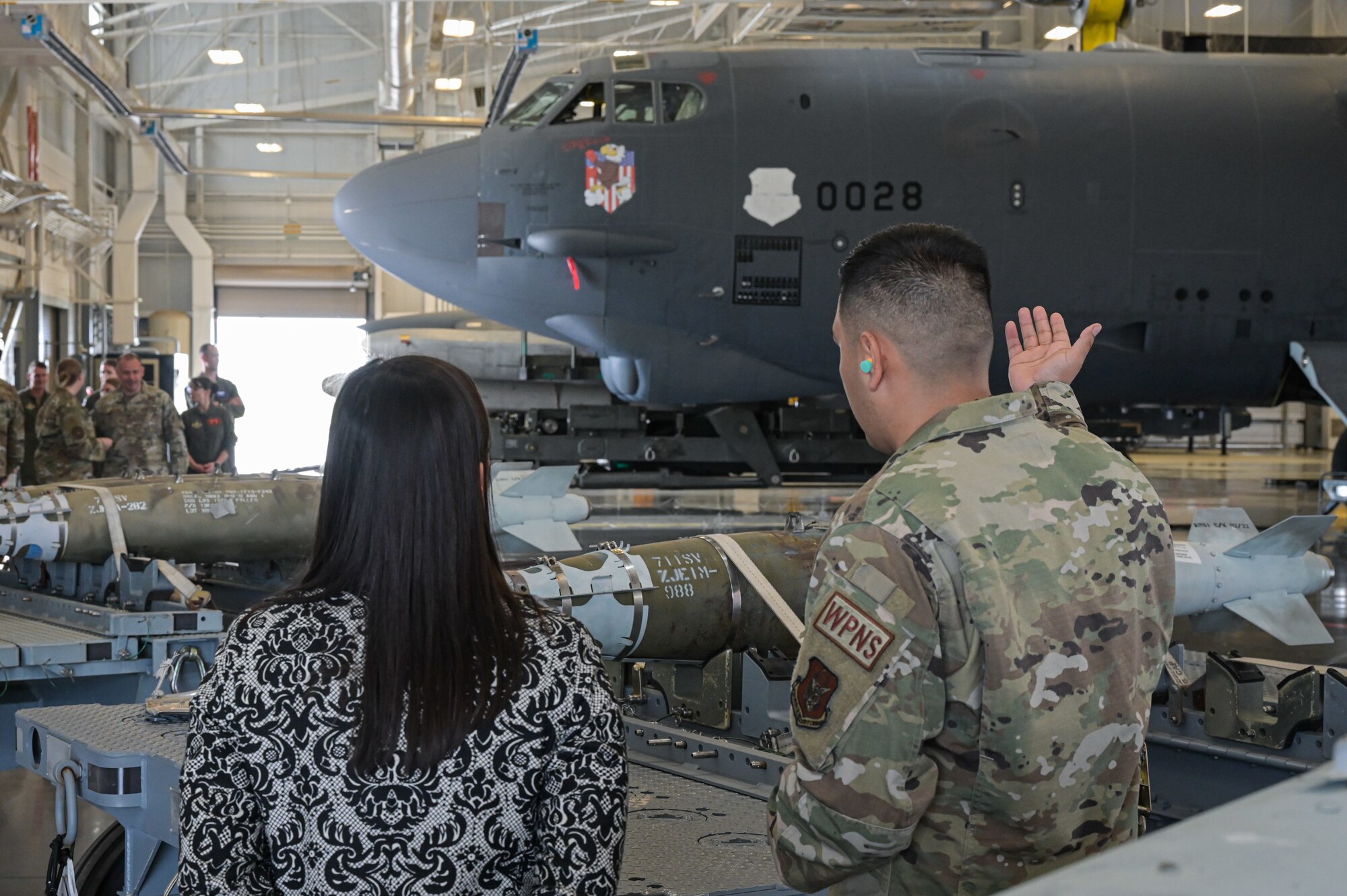 The Honorable Gina Ortiz Jones, Under Secretary of the Air Force, receives a brief by Tech. Sgt. Uriel Vargas from the 707th Maintenance Squadron at the Tech Sgt. Joshua Kidd’s Weapons Load Training Facility during a visit to Barksdale Air Force Base, Louisiana, April 12, 2022. Tech Sgt. Joshua Kidd’s Weapons Load Training Facility was named after Tech. Kidd, a 2nd Maintenance Group, loading standardization crew chief who was shot and killed outside of his house in Bossier City, Louisiana. (U.S. Air Force photo by Senior Airman Jonathan E. Ramos)