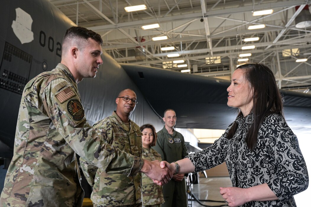 The Honorable Gina Ortiz Jones, Under Secretary of the Air Force, coins Staff Sgt. Dylan Schaeffer, 2nd Aircraft Maintenance Squadron B-52H Stratofortress E&E craftsman, at the Tech Sgt. Joshua Kidd’s Weapons Load Training Facility during a visit to Barksdale Air Force Base, Louisiana, April 12, 2022. Jones coined Airmen from the 2nd Bomb Wing acknowledging the importance of a job well done. (U.S. Air Force photo by Senior Airman Jonathan E. Ramos)