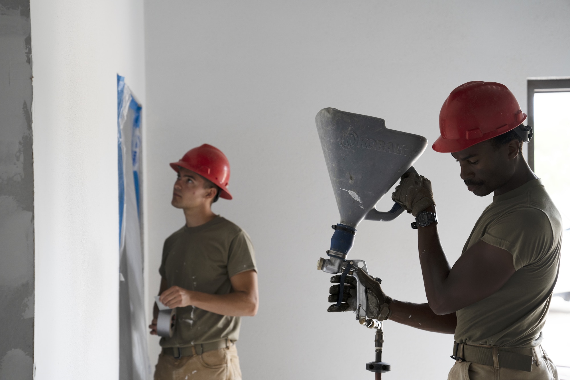 U.S. Air Force Senior Airmen Marcus Maiten and Russel Pennington, 823rd Rapid Engineer Deployable Heavy Operational Repair Squadron Engineer structural journeymen, apply plaster to walls in a new classroom at Keesler Air Force Base, Mississippi, April 13, 2022. The squadron is working to expand the Air Expeditionary Force compound to allow radio frequency transmissions and cyber transport courses increase efficiency in training. (U.S. Air Force photo by Airman 1st Class Trenten Walters)