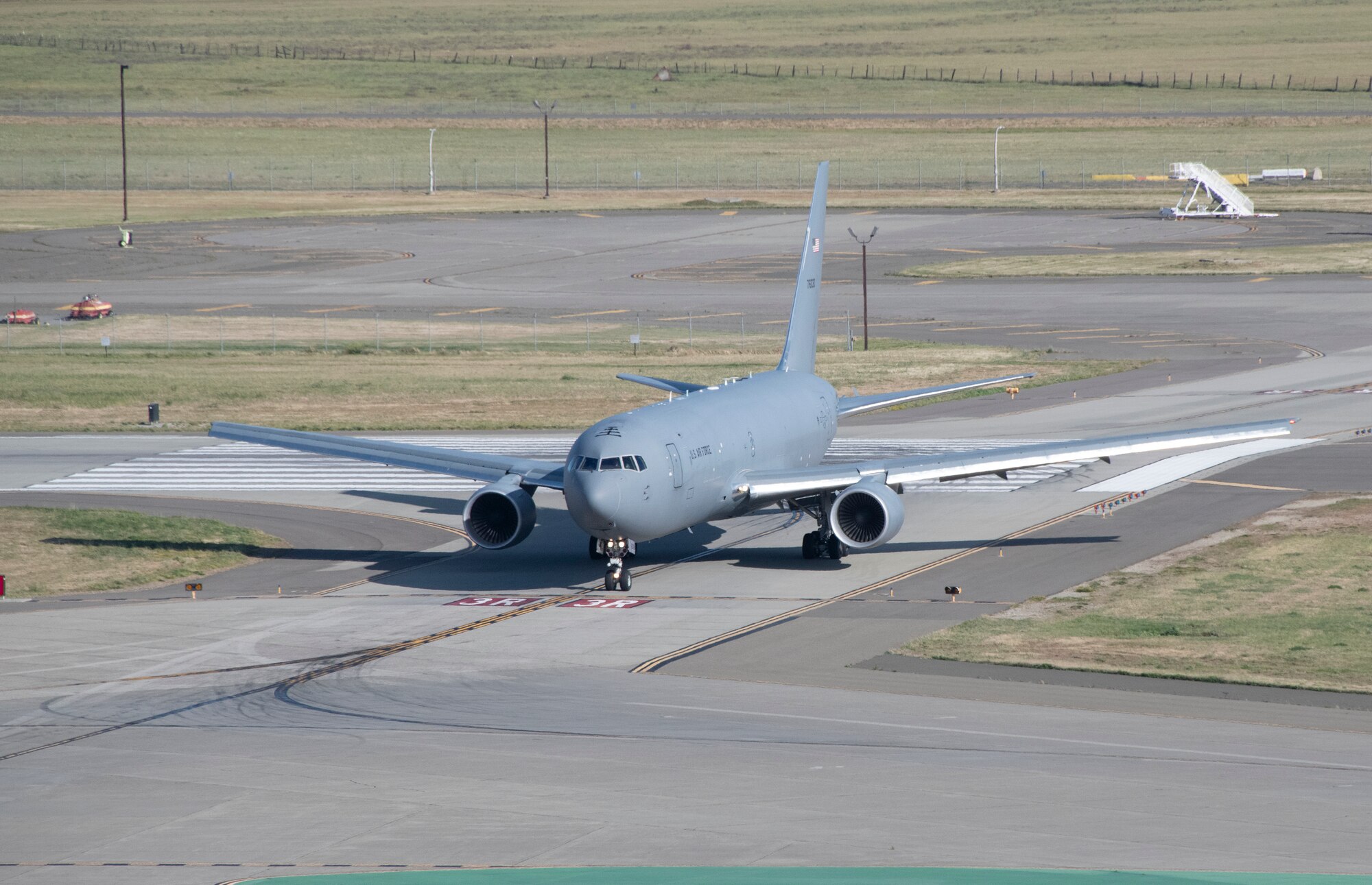 A U.S. Air Force KC-46A Pegasus taxies off the runway at Travis Air Force Base, California, April 12, 2022. Ten KC-46A Pegasus tankers and eight KC-135RT Stratotankers were relocated to Travis AFB from McConnell AFB as a precaution due to the possibility of severe weather impacting the Wichita area. (U.S. Air Force photo by Heide Couch)