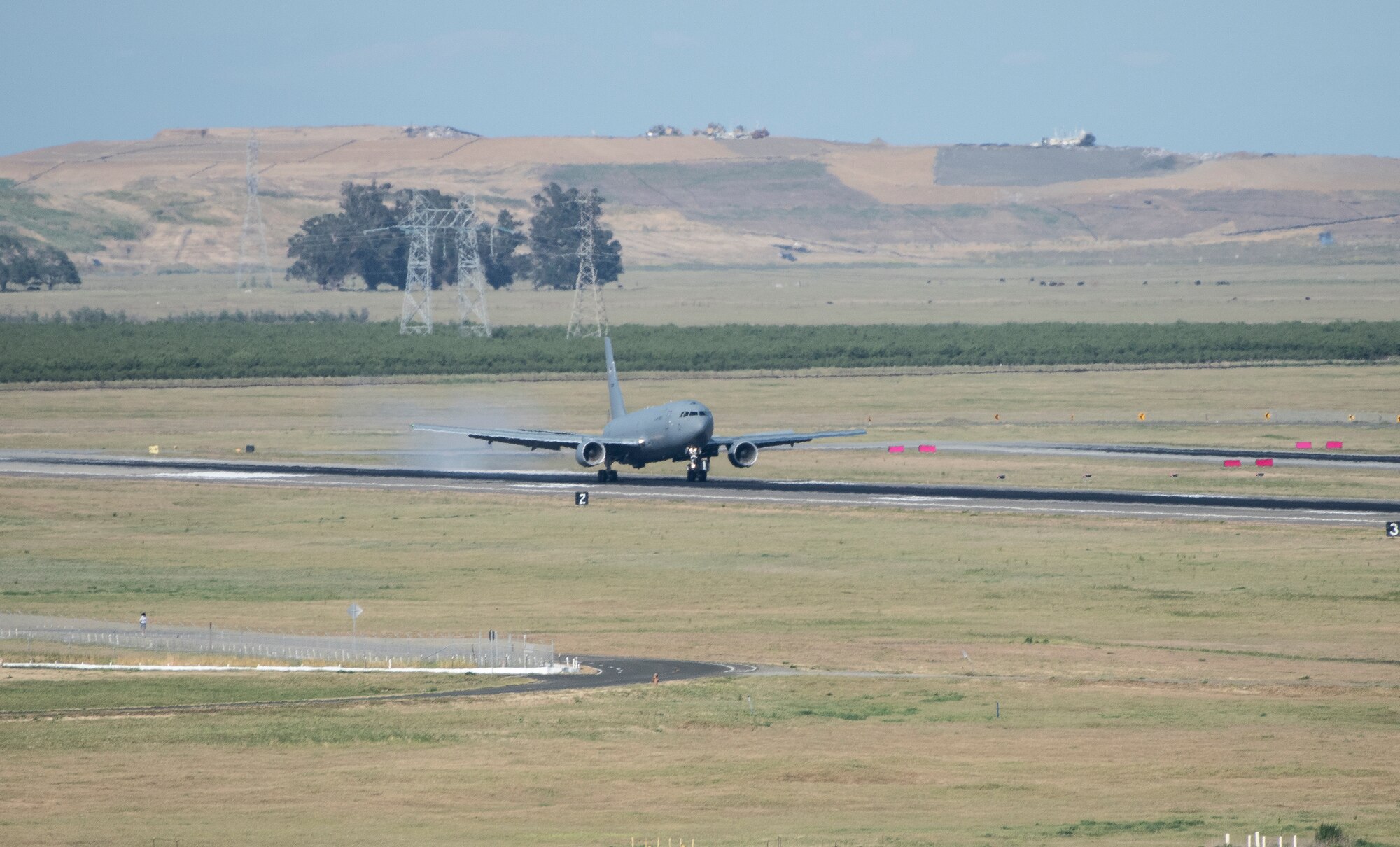 A U.S. Air Force KC-46A Pegasus touches down on the runway at Travis Air Force Base, California, April 12, 2022. Ten KC-46A Pegasus tankers and eight KC-135RT Stratotankers were relocated to Travis AFB from McConnell AFB as a precaution due to the possibility of severe weather impacting the Wichita area. (U.S. Air Force photo by Heide Couch)
