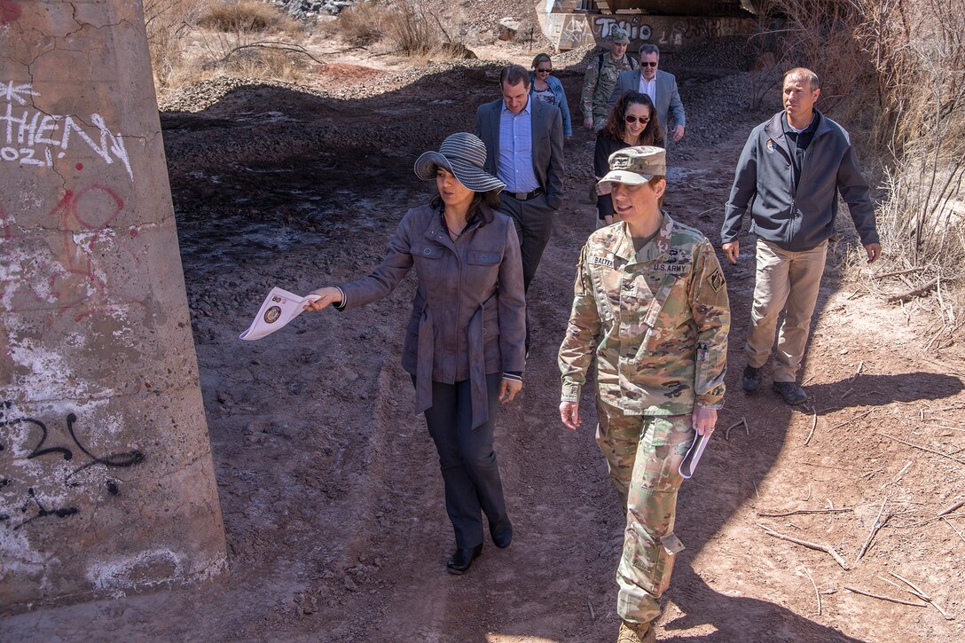 Priyanka Wadhawan, project manager with the Programs and Project Management Division, U.S. Army Corps of Engineers Los Angeles District, left, discusses the Little Colorado River at Winslow Flood-Control project with Col. Julie Balten, the Corps’ LA District commander, right, and others during a tour of the project April 6 in Winslow, Ariz.