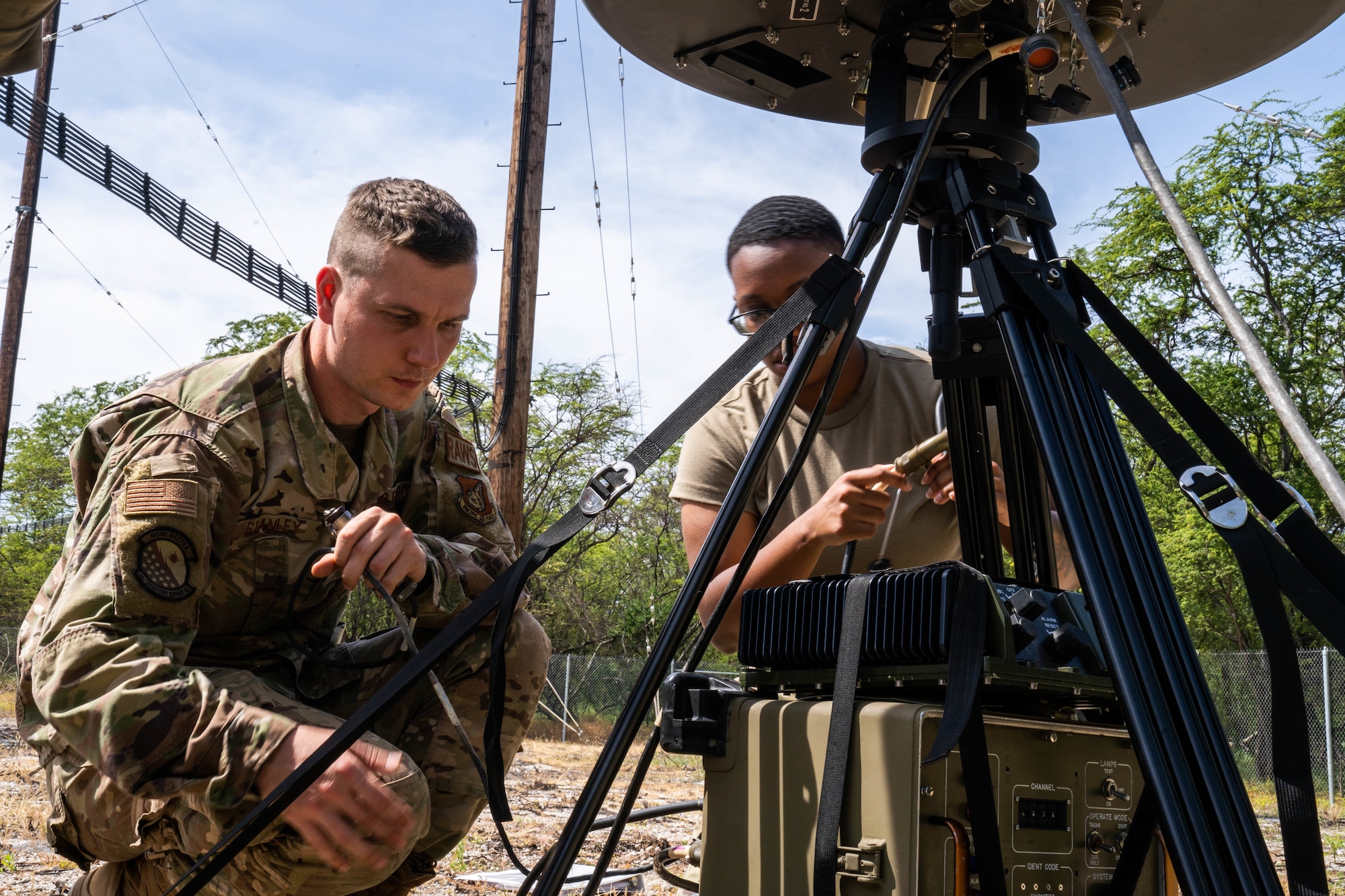 Senior Airman Troy Stanley, 15th Operation Support Squadron Radar, Airfield and Weather Systems Shop, connects the azimuth monitor to the Tactical Navigation System for a training exercise at Joint Base Pearl Harbor-Hickam, Hawaii, March 15, 2022. The TACAN is a radio air-navigation system that provides aircrew distance information as a guide to show their geographical location and is usually used by combat controllers in remote airfields. (U.S. Air Force photo by Airman 1st Class Makensie Cooper)