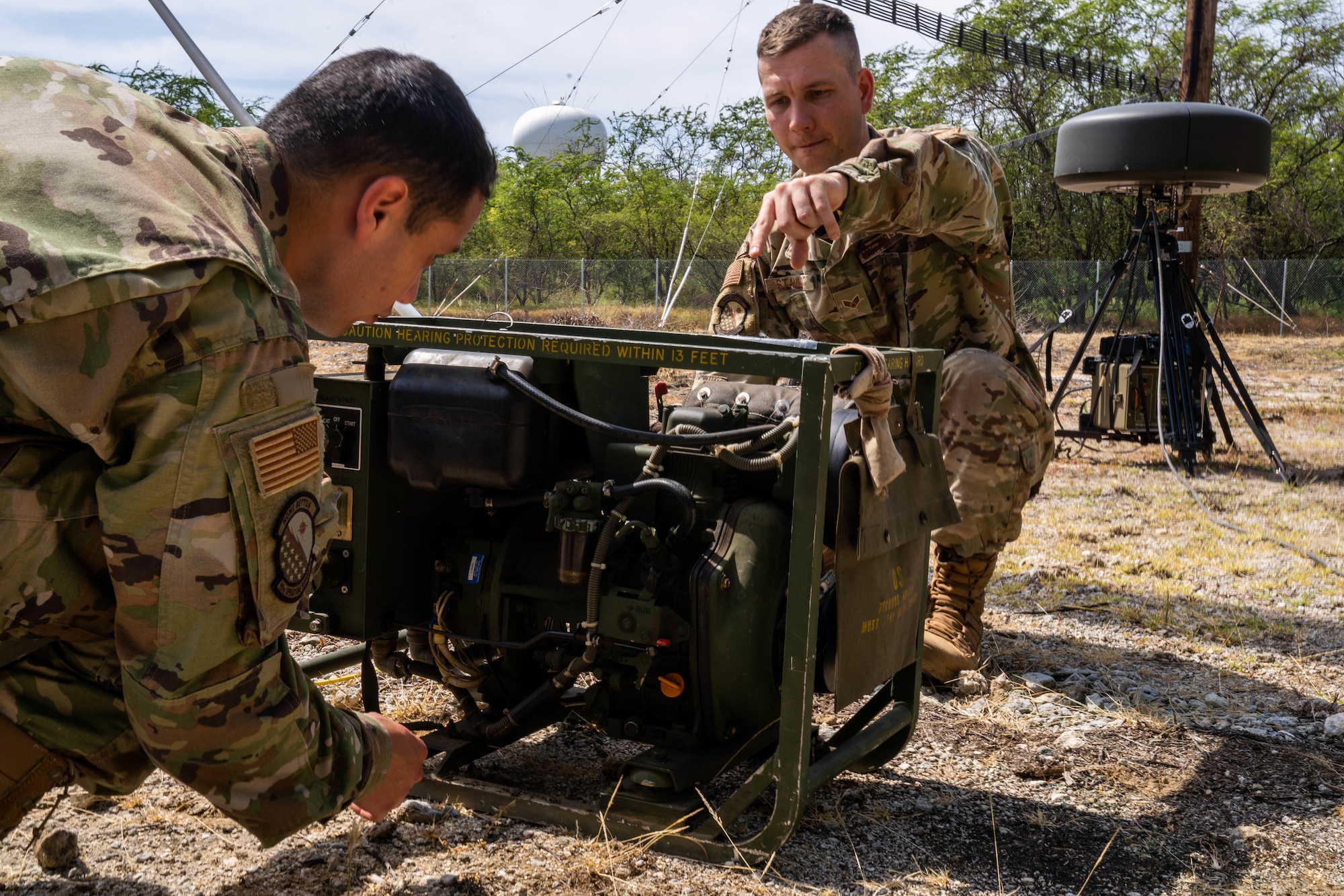 Senior Airman Troy Stanley, 15th Operation Support Squadron Radar, Airfield and Weather Systems Shop, starts the generator to run the Tactical Navigation System for a training exercise at Joint Base Pearl Harbor-Hickam, Hawaii, March 15, 2022. The TACAN is a radio air-navigation system that provides aircrew distance information as a guide to show their geographical location and is usually used by combat controllers in remote airfields. (U.S. Air Force photo by Airman 1st Class Makensie Cooper)