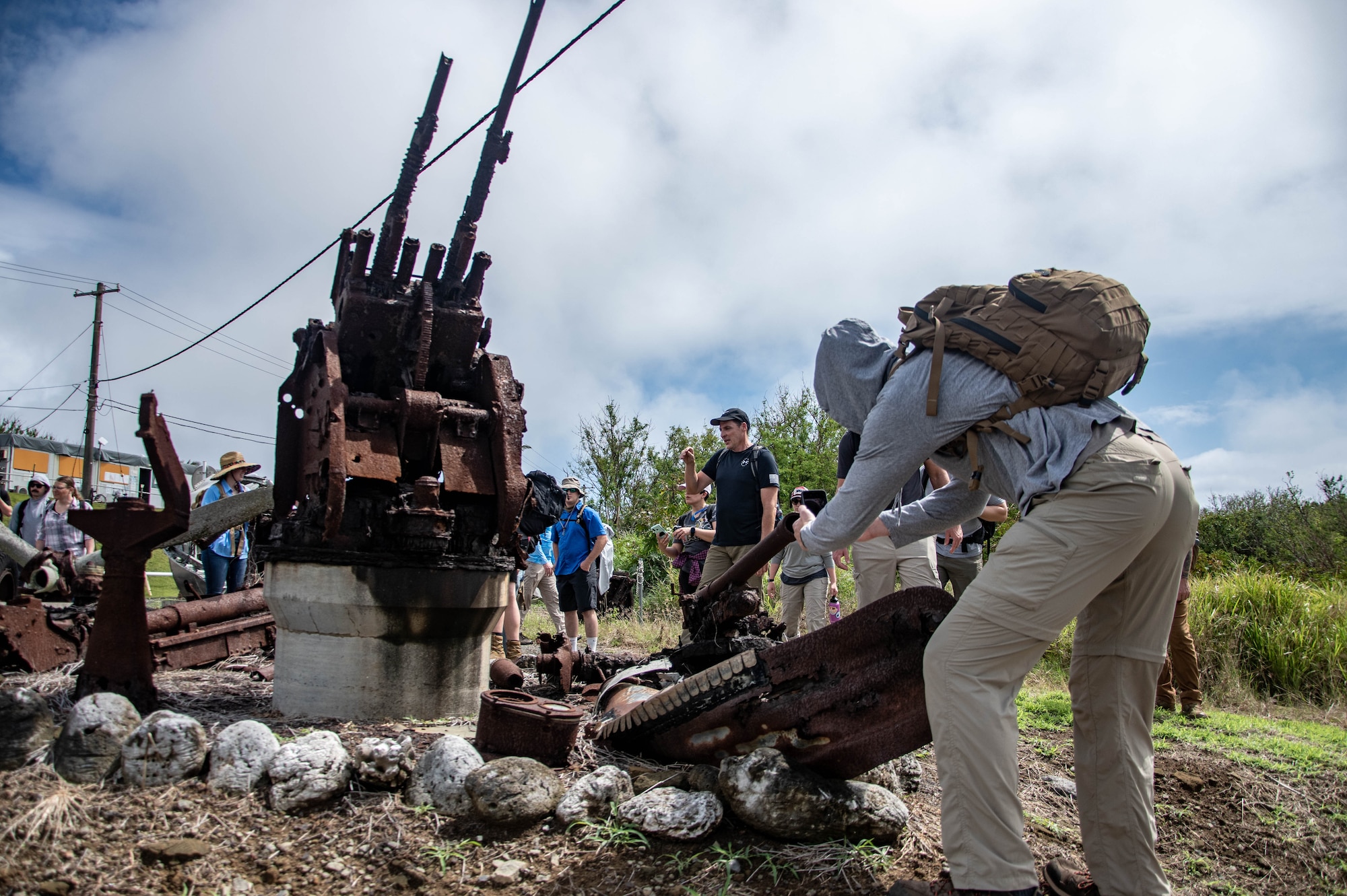 Airmen and Marines look at ruins.