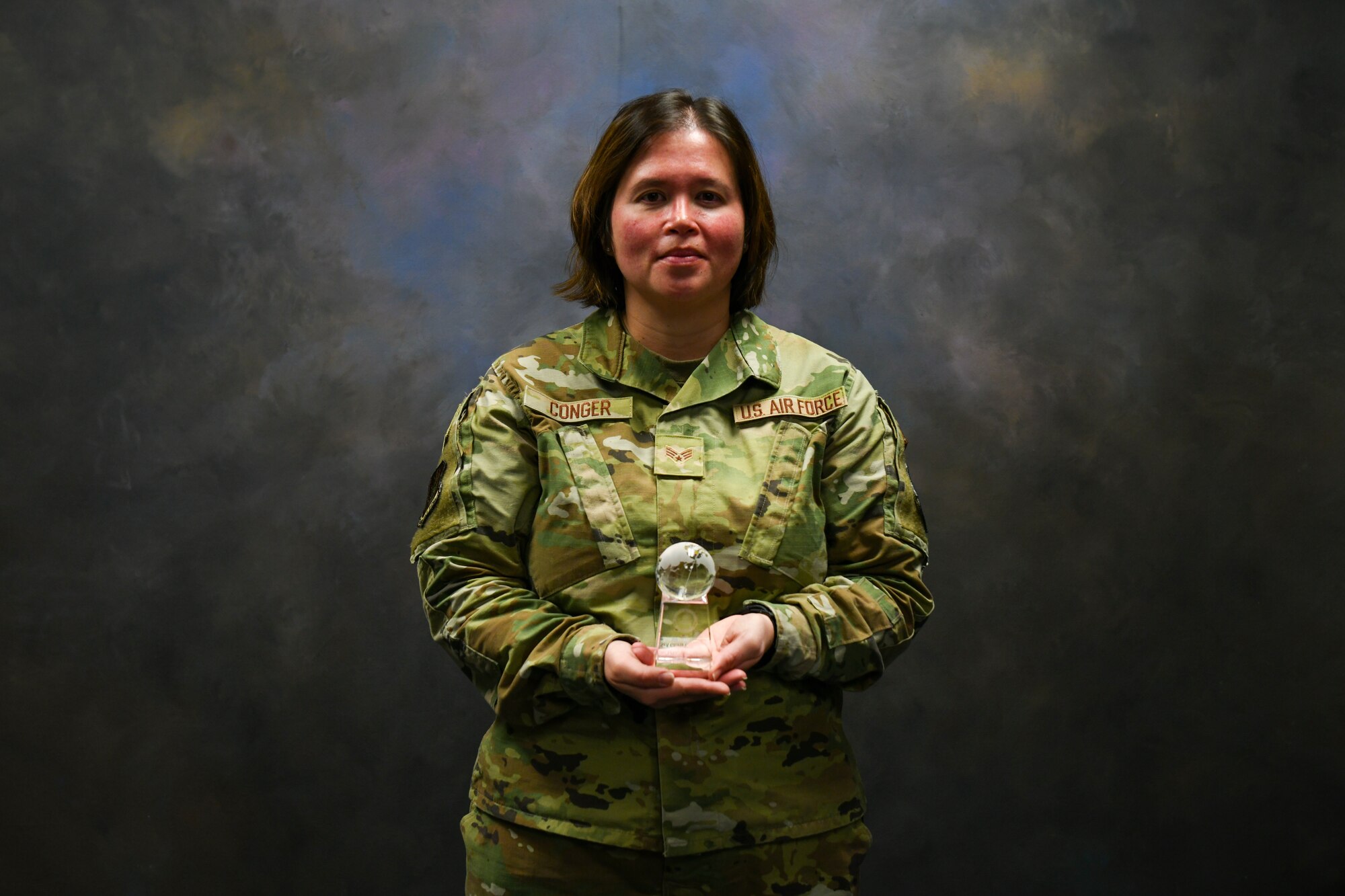 U.S. Air Force Senior Airman Gloria Conger, 97th Air Mobility Wing command post emergency actions controller, poses for a photo at Altus Air Force Base, Oklahoma, April 5, 2022. Conger earned the 2021 Air Education and Training Command Airman of the Year Award. (U.S. Air Force photo by Airman 1st Class Miyah Gray)
