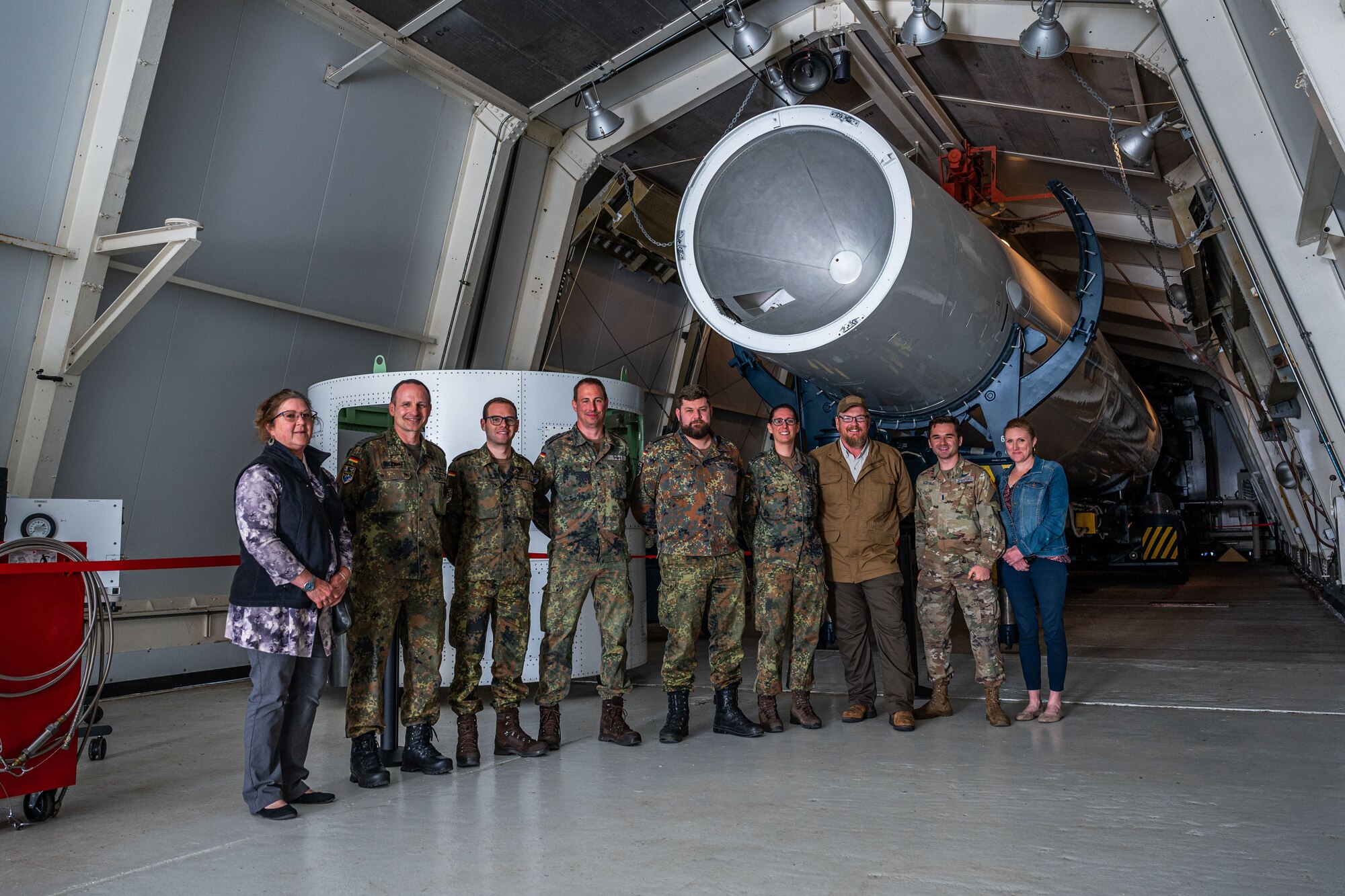 Group photo in front of historical launch memorabilia from Vandenberg.