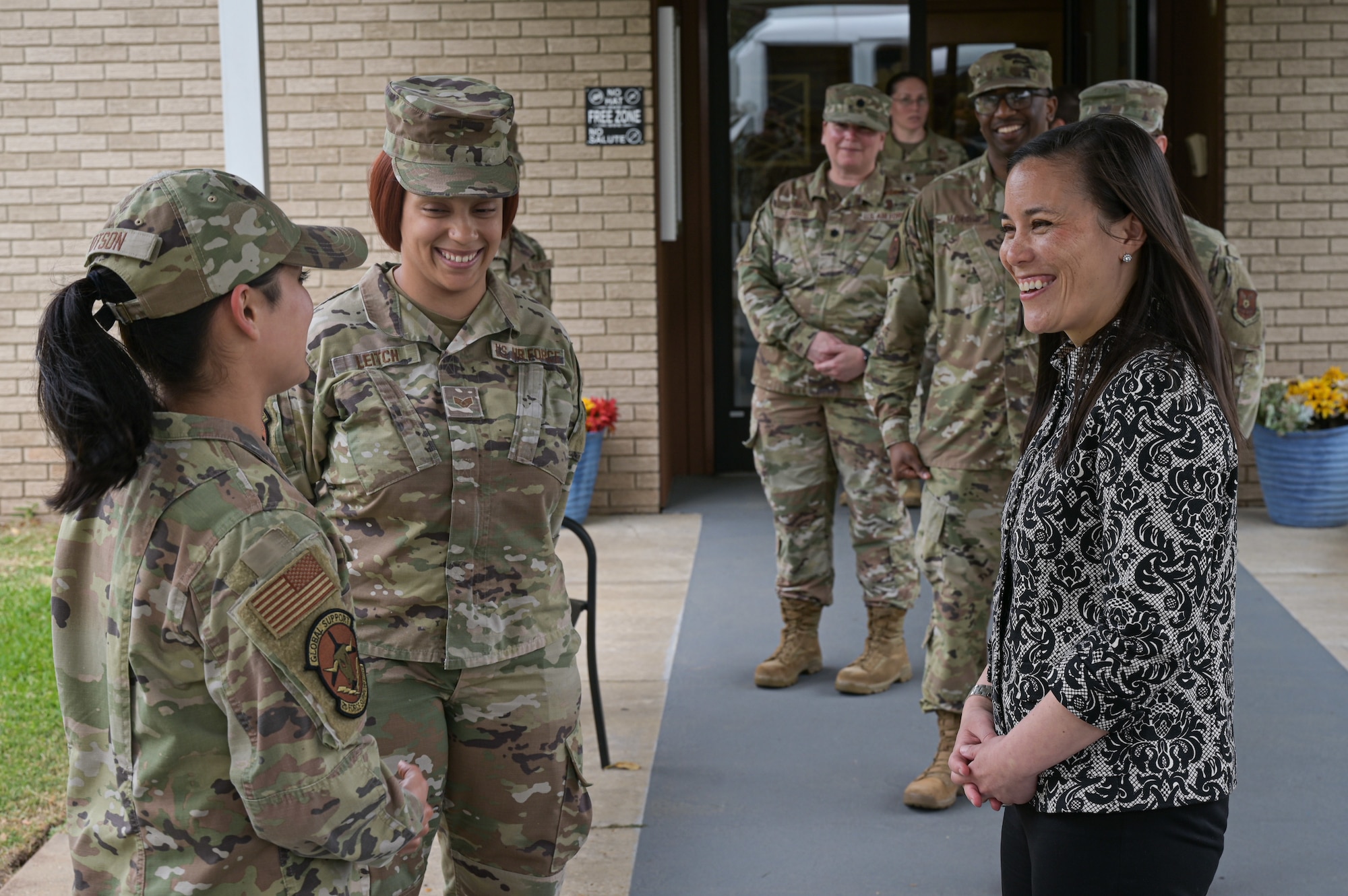 The Honorable Gina Ortiz Jones, Under Secretary of the Air Force, converses with Airman 1st Class Sigrith Johnson, 2nd Force Support Squadron  food service apprentice, during a visit to Barksdale Air Force Base, Louisiana, April 12, 2022. Jones coined Airmen from the 2nd Bomb Wing acknowledging their superior performance. (U.S. Air Force photo by Senior Airman Jonathan E. Ramos)