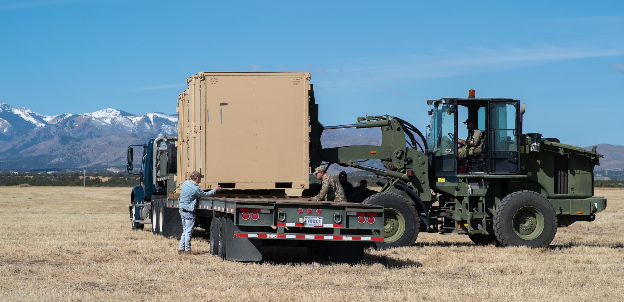 Air Commandos from the 27th Special Operations Logistics Readiness Squadron load cargo containers onto a flatbed trailer during teardown as the 27th Special Operations Mission Support Group, Detachment 1 Mission Sustainment Team 2 ends the Full Mission Profile 22-3 exercise at Sierra Blanca Regional Airport. (U.S. Air Force photo by Senior Airman Christopher Storer)