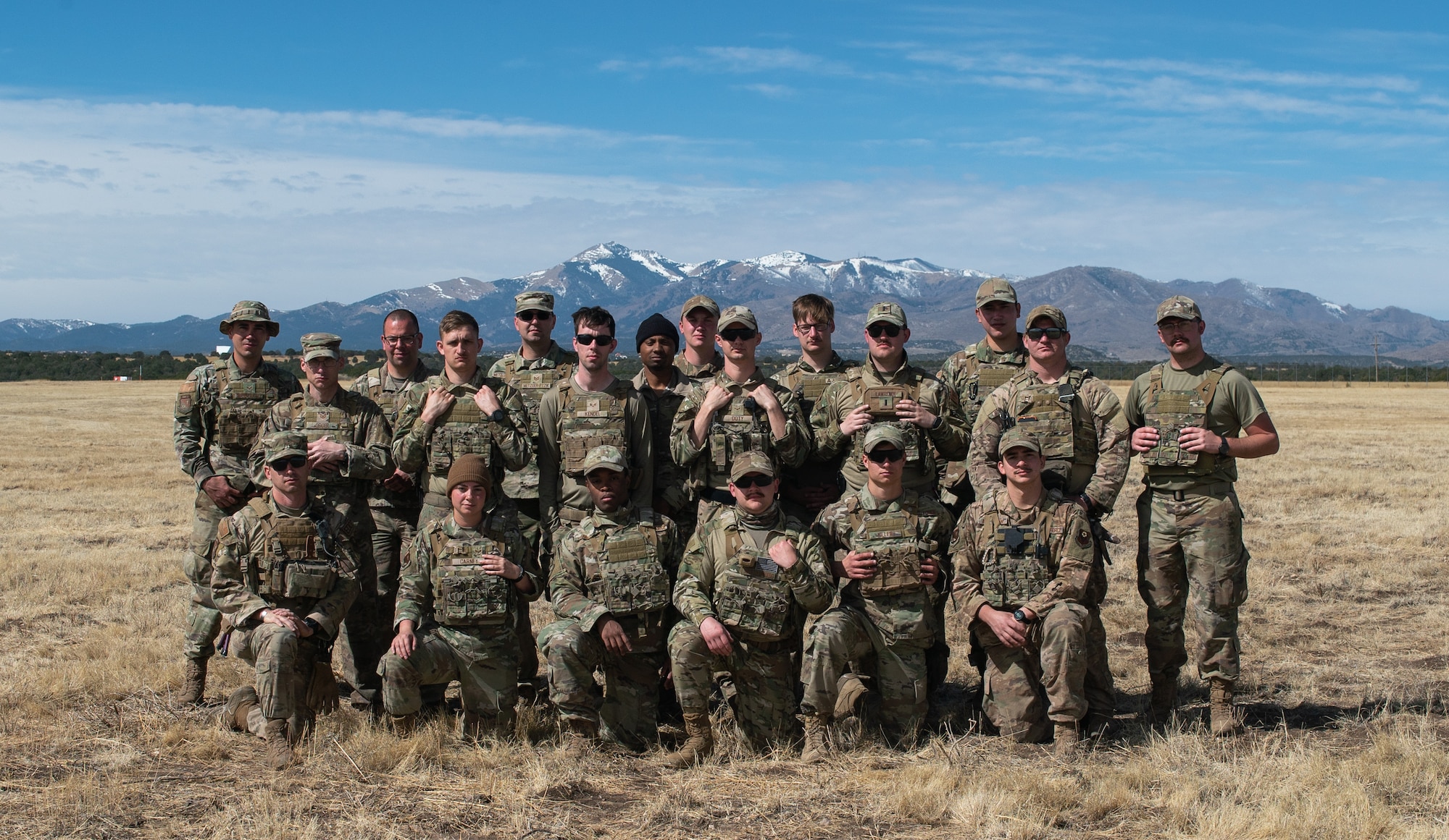 The 27th Special Operations Mission Support Group, Detachment 1 Mission Sustainment Team 2 poses for a photo in front of the Sierra Blanca mountains during the Full Mission Profile 22-3 exercise, at the Sierra Blanca Regional Airport, New Mexico. (U.S. Air Force photo by Senior Airman Christopher Storer)