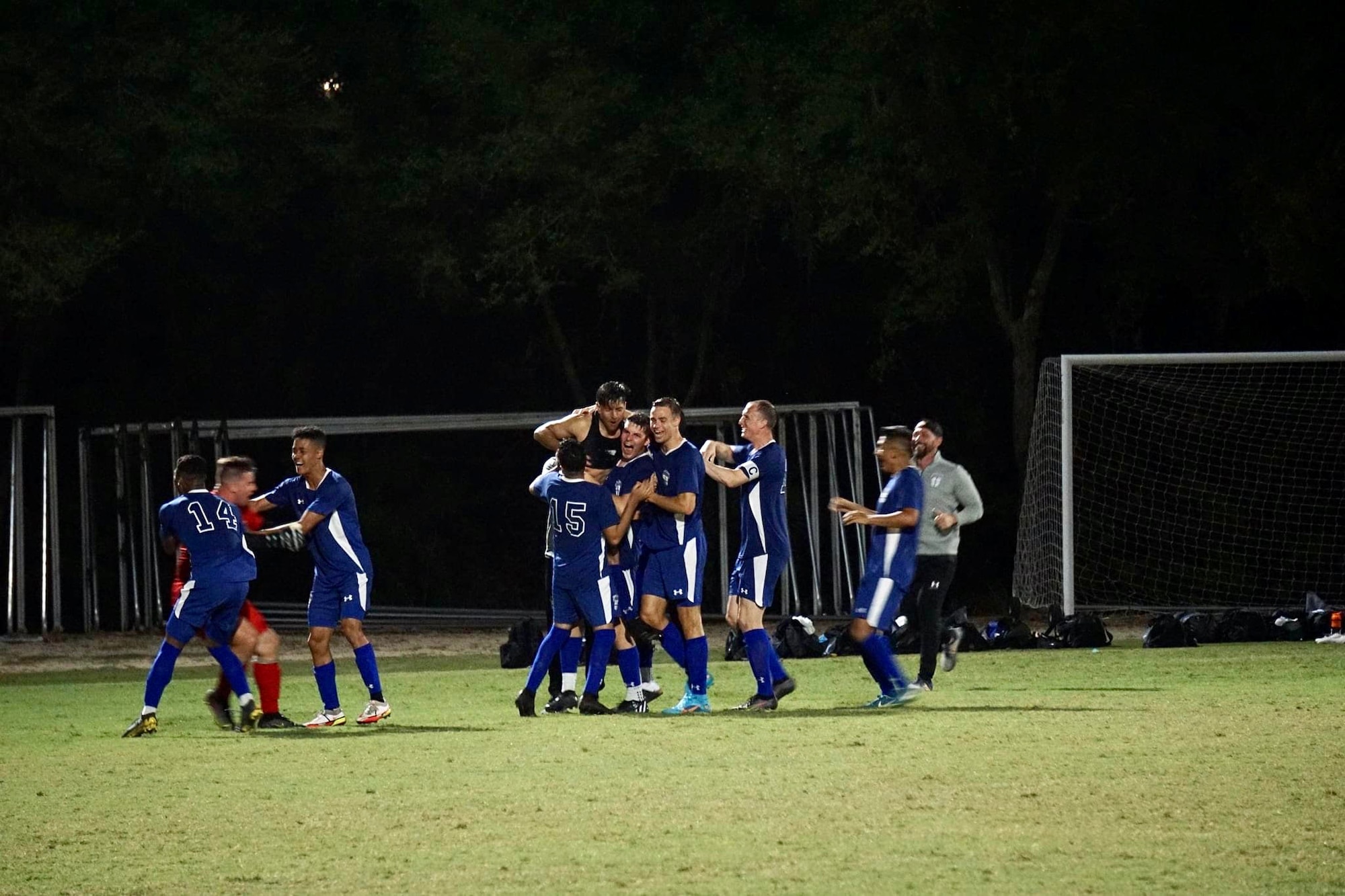 Service members play soccer.