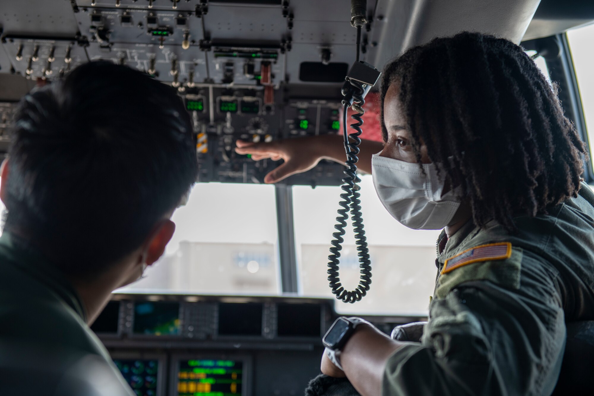A U.S. Air Force Airman and Japan Air Self-Defense Force member performs pre-flight inspections inside a C-130J Super Hercules