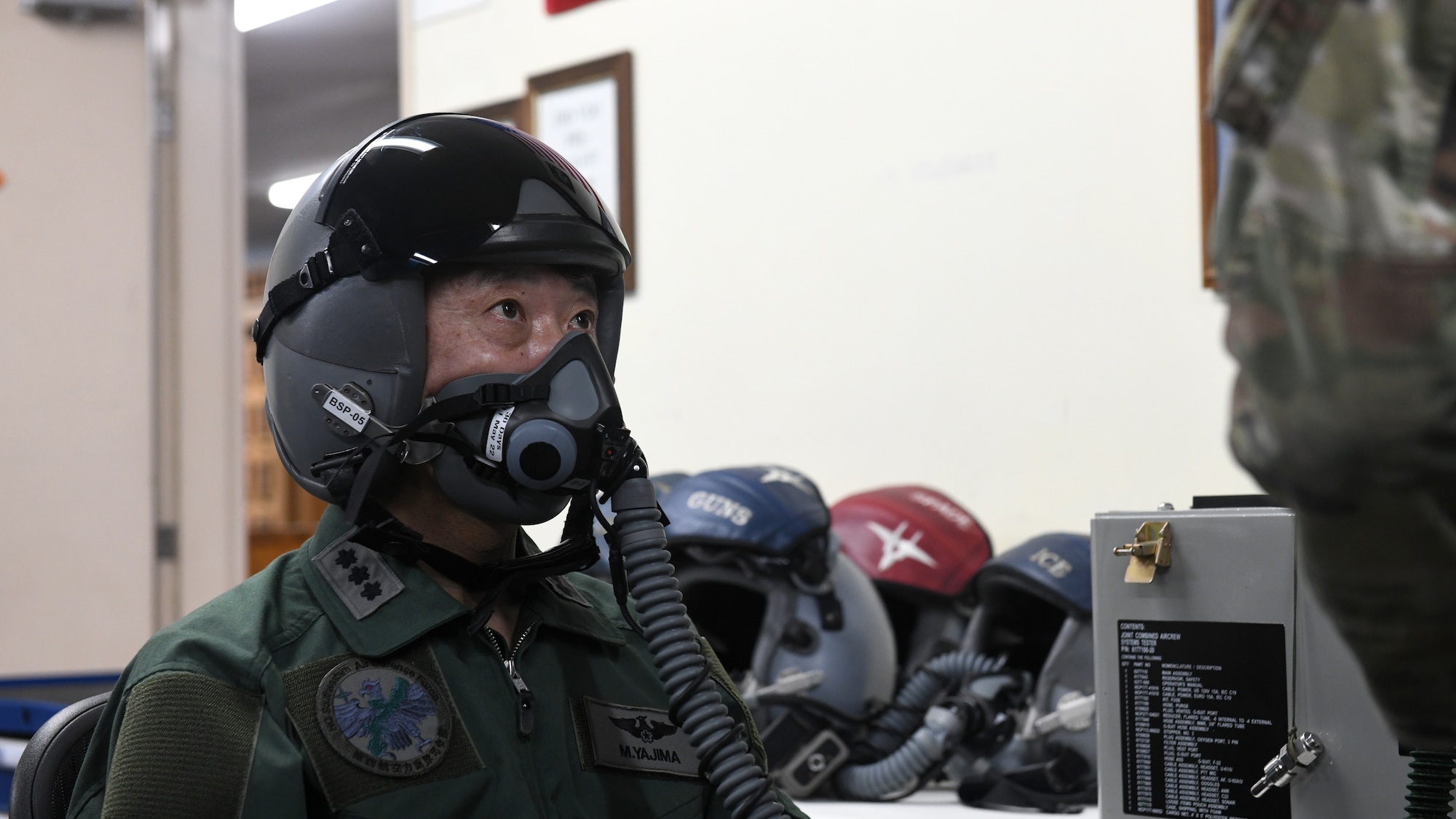 Japan Air Self-Defense Force Lt. Gen. Masahito Yajima, Southwestern Air Defense Force commander, tests an oxygen mask prior to a familiarization flight at Kadena Air Base, Japan, April 12, 2022. Yajima’s visit to Kadena highlighted the 18th Wing's commitment to strengthening the alliance between U.S. and Japanese forces by fortifying their combined combat capabilities in support of a free and open Indo-Pacific. (U.S. Air Force photo by Staff Sgt. Benjamin Raughton)
