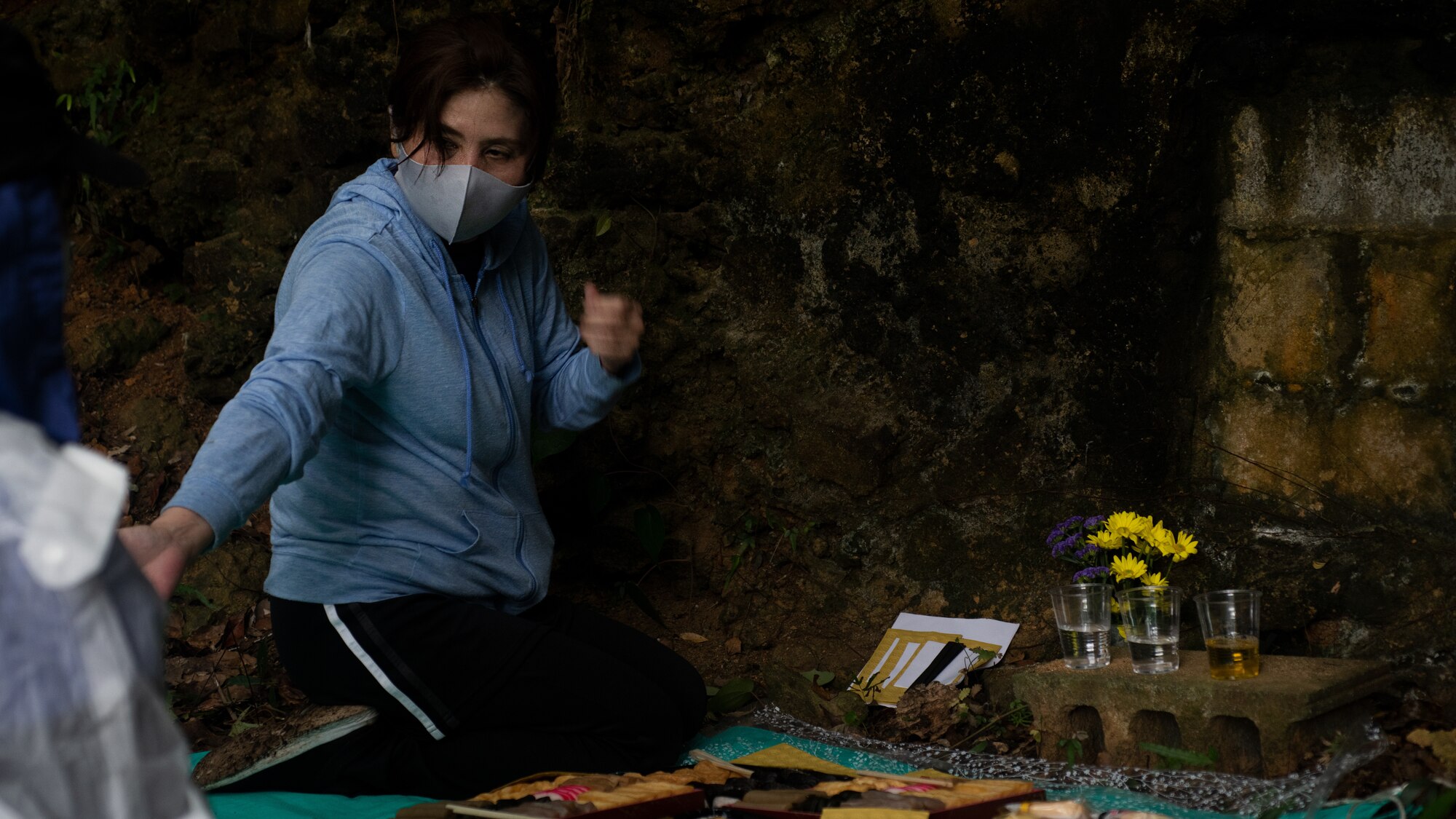 A local woman and her family prepare offerings to a family shrine.