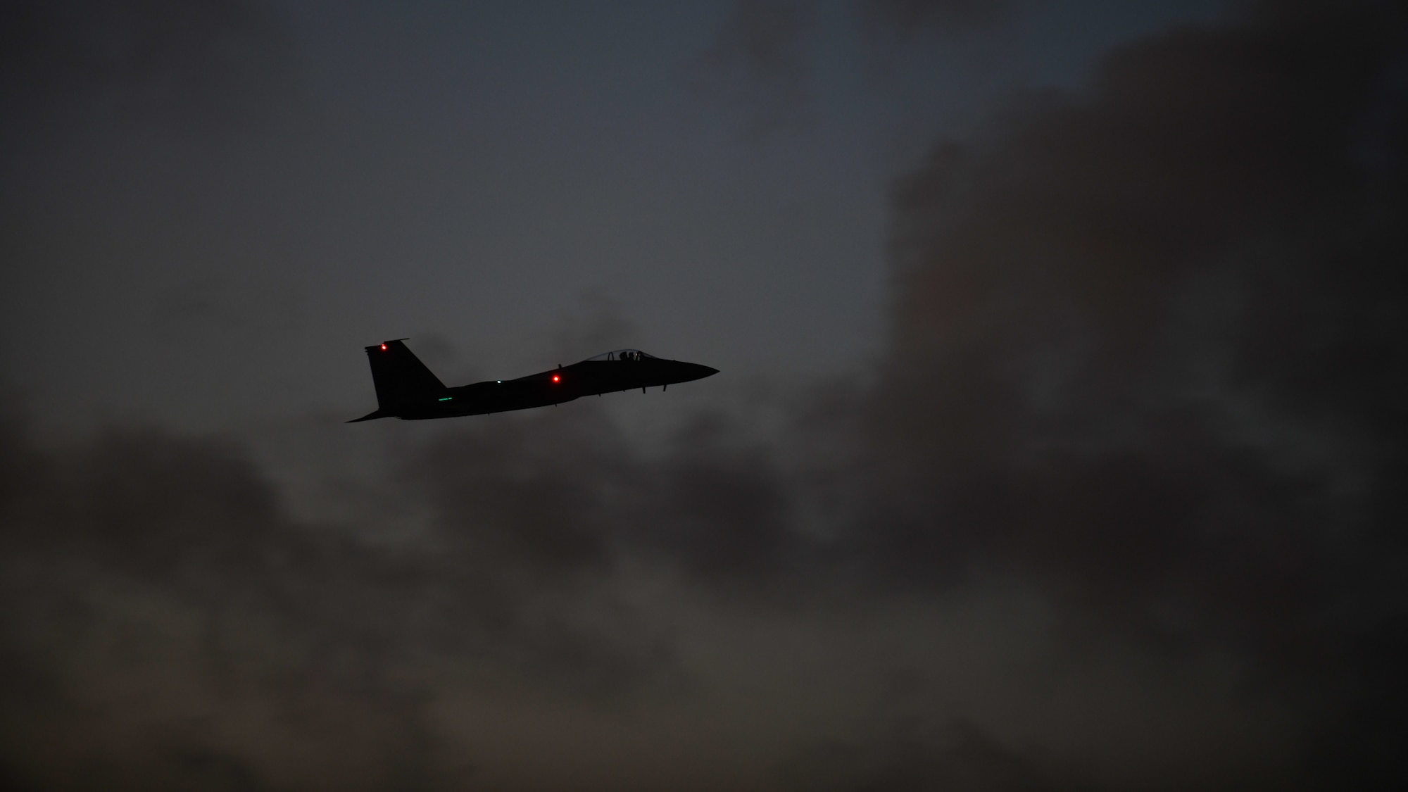An F-15C Eagle assigned to the 44th Fighter Squadron flies overhead at Kadena Air Base, Japan, April 12, 2022. Night flying operations enable aircrew, maintainers and support personnel to hone their skills and ensure Team Kadena maintains a ready force to support the Indo-Pacific region. (U.S. Air Force photo by Staff Sgt. Benjamin Raughton)