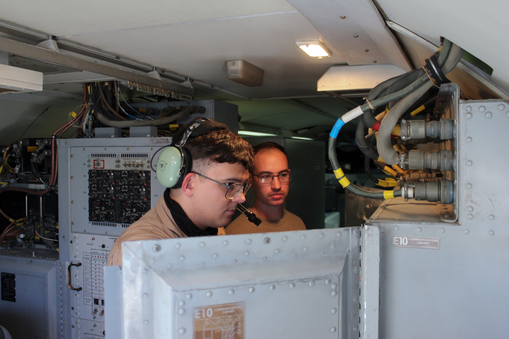 airborne radio operators, review radio communication system controls aboard an E-3 Sentry