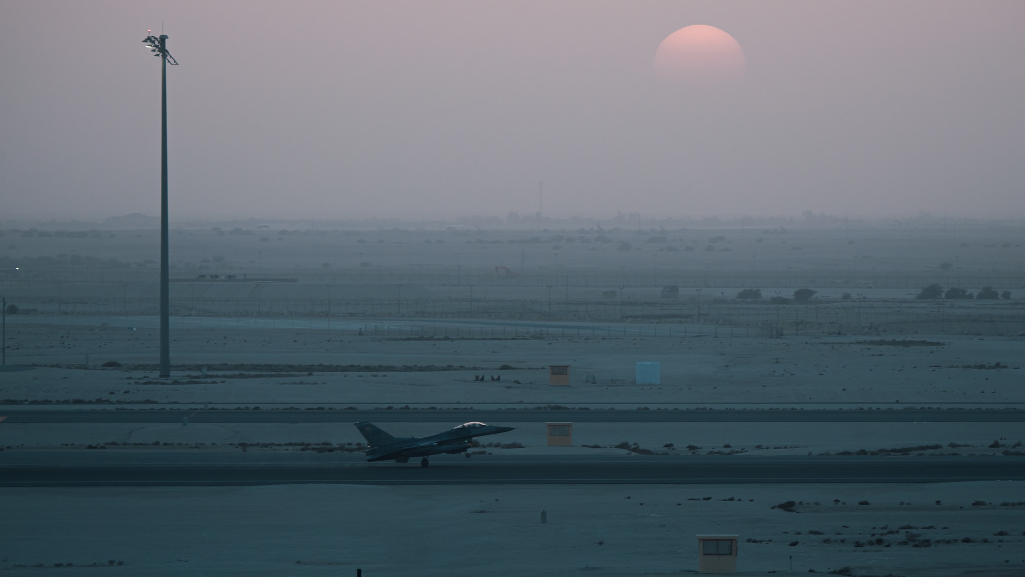 A U.S. Air Force F-16 Fighting Falcon lands at Al Udeid Air Base, Qatar