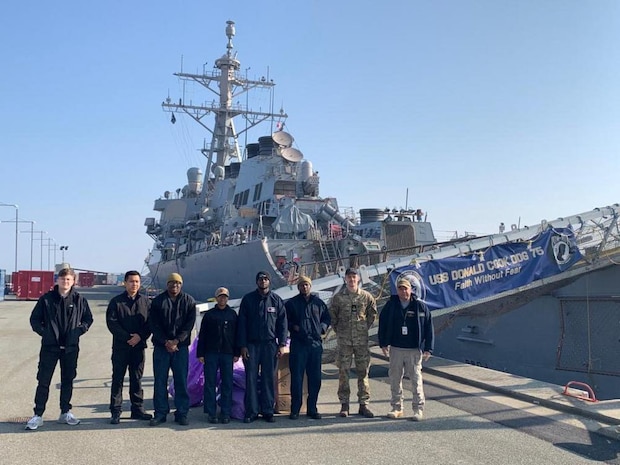 Logisticians assigned to Naval Supply Systems Command Fleet Logistics Center Sigonella and Danish sailors load USS Donald Cook March 21, 2022. Prior to pulling into port, The Sullivans and Donald Cook participated in NATO exercise Dynamic Guard Feb. 22-25 with Royal Danish Navy Iver Huitfeldt-class frigate HDMS Peter Willemoes (F362).