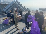 Logisticians assigned to Naval Supply Systems Command Fleet Logistics Center Sigonella and Danish sailors load USS Donald Cook March 21, 2022. Prior to pulling into port, The Sullivans and Donald Cook participated in NATO exercise Dynamic Guard Feb. 22-25 with Royal Danish Navy Iver Huitfeldt-class frigate HDMS Peter Willemoes (F362).