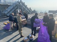 Logisticians assigned to Naval Supply Systems Command Fleet Logistics Center Sigonella and Danish sailors load USS Donald Cook March 21, 2022. Prior to pulling into port, The Sullivans and Donald Cook participated in NATO exercise Dynamic Guard Feb. 22-25 with Royal Danish Navy Iver Huitfeldt-class frigate HDMS Peter Willemoes (F362).