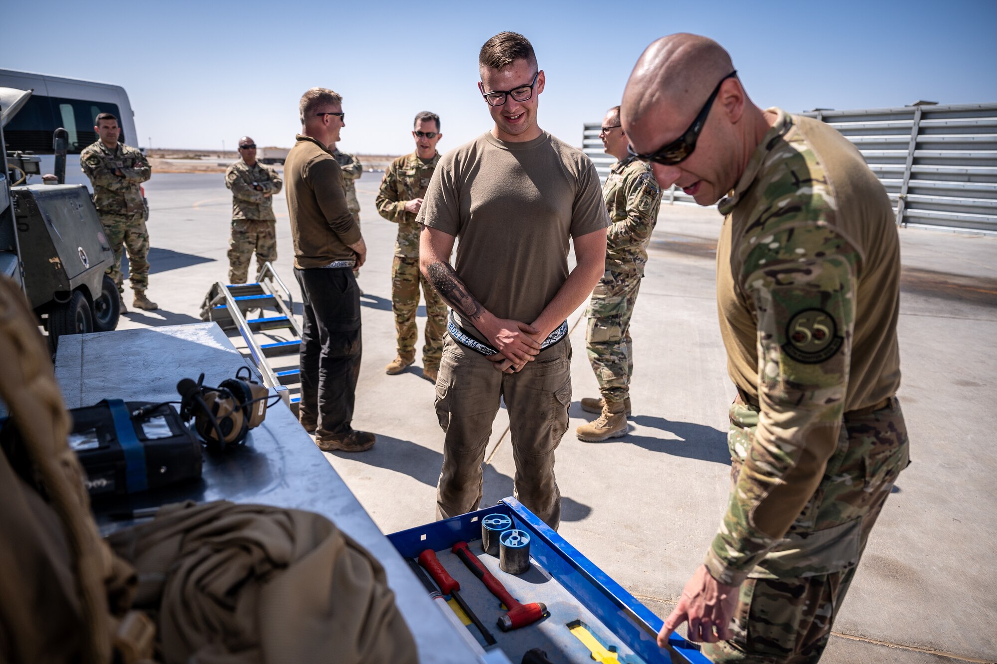Airman First Class Jason Buzard, 55th Expeditionary Fighter Generation Squadron crew chief, gives Chief Master Sgt. Sean Milligan, 332nd Air Expeditionary Wing command chief, a tour of the delta ramp and some of the tools used to support daily operations at an undisclosed location in Southwest Asia, April 9, 2022. (U.S. Air Force photo by Christopher Parr)