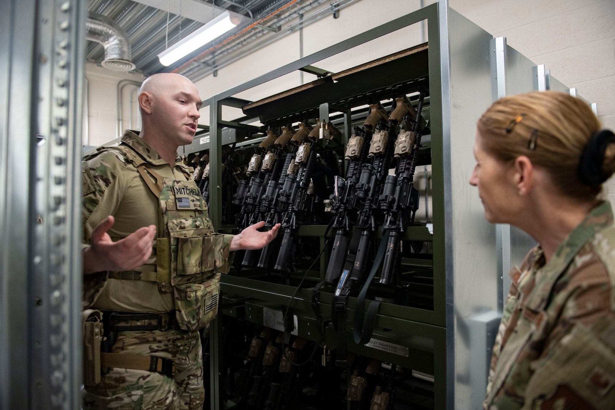 U.S. Air Force Staff Sgt. Kevin Mitchell, 422d Security Forces Squadron non-commissioned officer in charge of the armory, left, tells Col. Lisa Wildman, 501st Combat Support Wing vice commander, about the changes made to the armory at RAF Croughton, England, April 6, 2022. The armory was the first in the entire Air Force to fully integrate a radio-frequency identification tracking system. (U.S. Air Force photo by Senior Airman Jason W. Cochran)