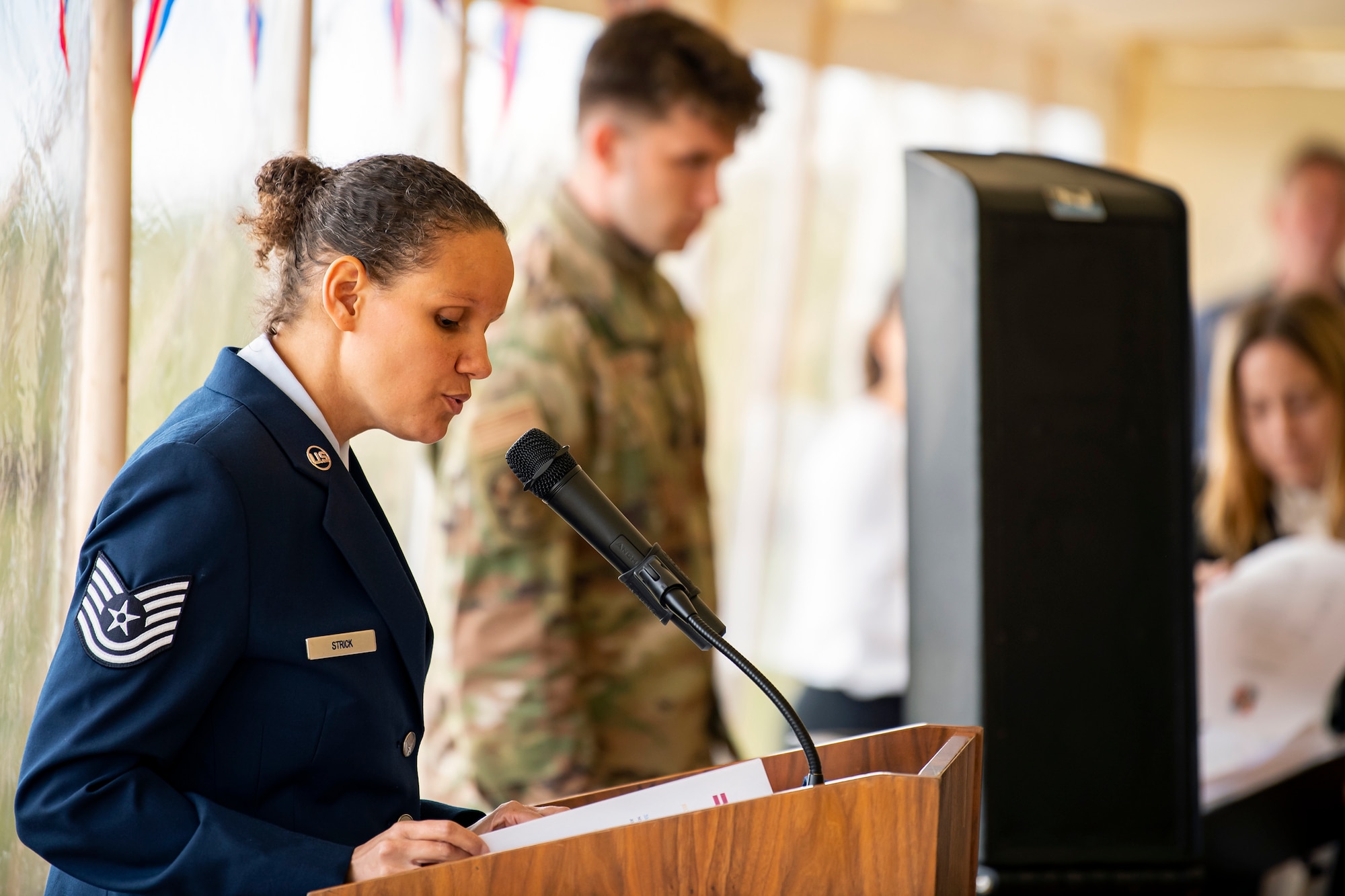 U.S. Air Force Tech Sgt. Valerie Strick, 422d Air Base Group executive officer, gives opening remarks during the Queen’s Green Canopy event at RAF Croughton, England, April 13, 2022. The event celebrated the Queen’s Platinum Jubilee initiative, marking the 70th year of her reign. During the event, trees were planted to create a legacy in honor of the queen’s leadership of the nation. (U.S. Air Force photo by Staff Sgt. Eugene Oliver)
