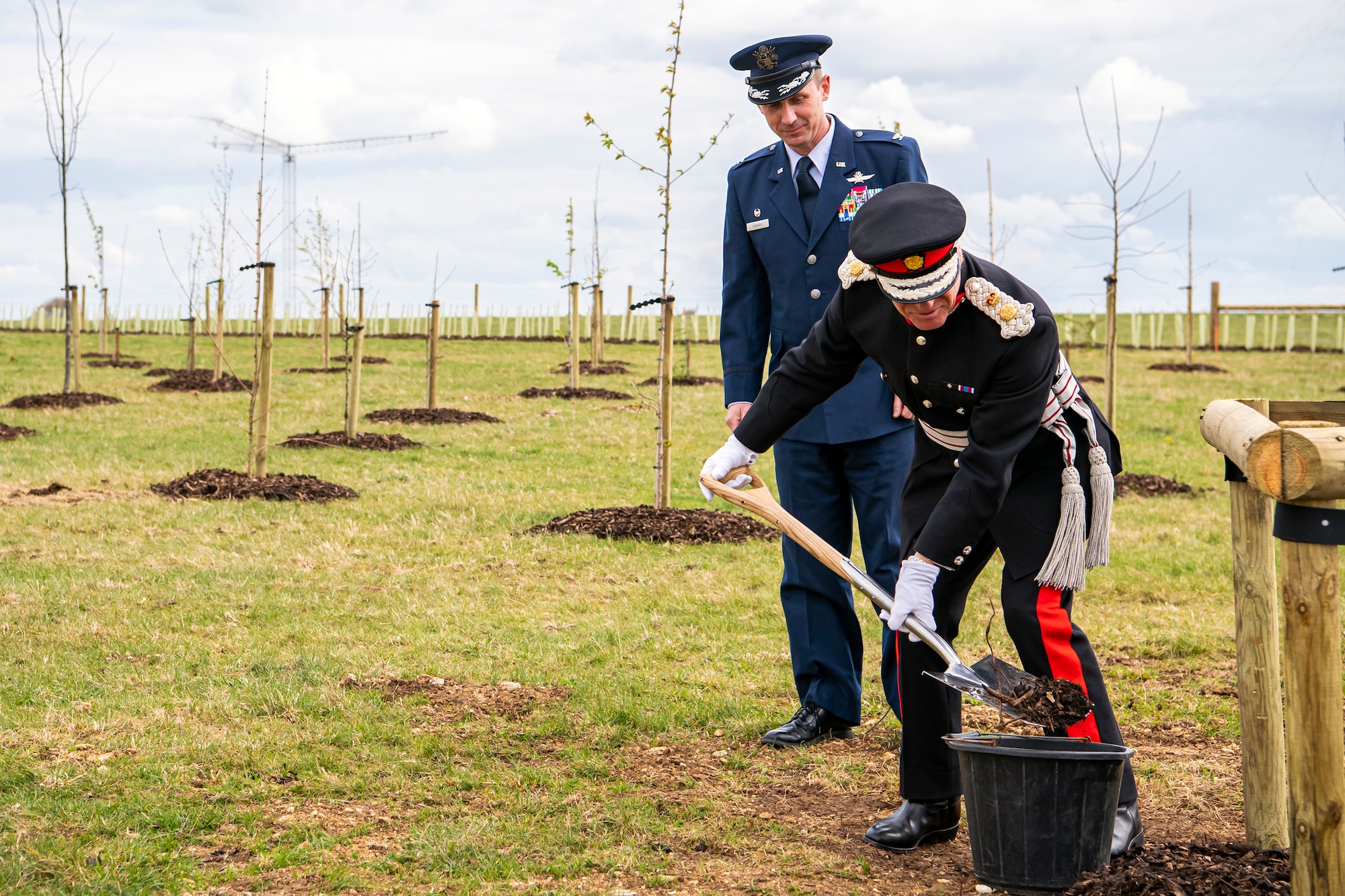 James Saunders-Watson, Lord-Lieutenant of Northamptonshire, digs up dirt to plant a tree during the Queen’s Green Canopy event at RAF Croughton, England, April 13, 2022. The event celebrated the Queen’s Platinum Jubilee initiative, marking the 70th year of her reign. During the event, trees were planted to create a legacy in honor of the queen’s leadership of the nation. (U.S. Air Force photo by Staff Sgt. Eugene Oliver)