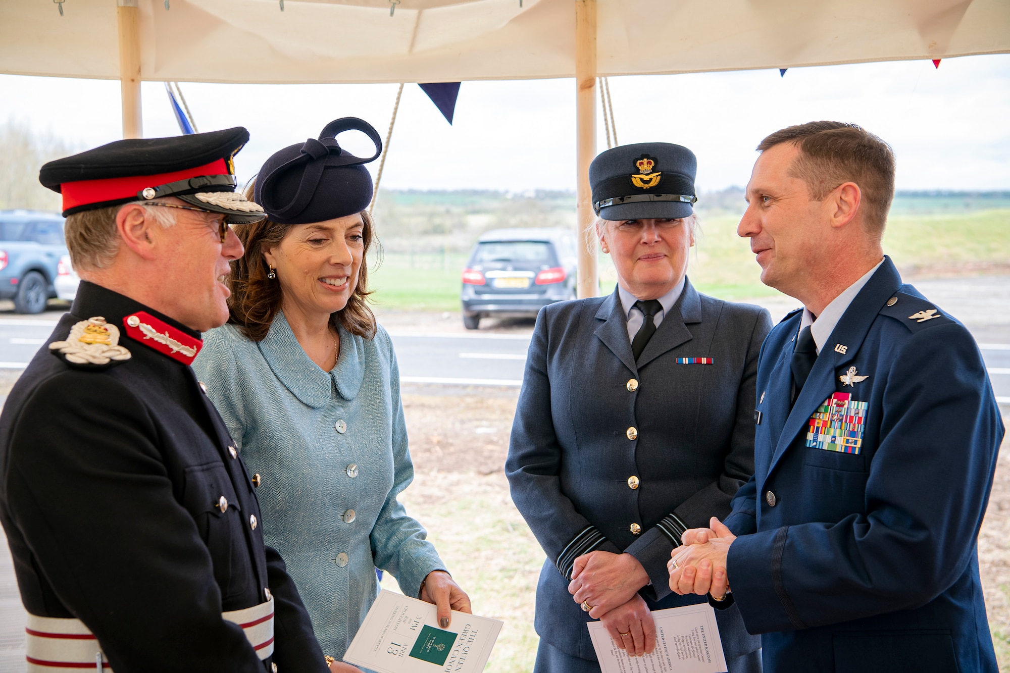 U.S. Air Force Col. Jon T. Hannah, left, 422d Air Base Group commander, speaks with James Saunders-Watson, right,  Lord-Lieutenant of Northamptonshire, and other distinguished guests prior to the Queen’s Green Canopy event at RAF Croughton, England, April 13, 2022. The event celebrated the Queen’s Platinum Jubilee initiative, marking the 70th year of her reign. During the event, trees were planted to create a legacy in honor of the queen’s leadership of the nation. (U.S. Air Force photo by Staff Sgt. Eugene Oliver)