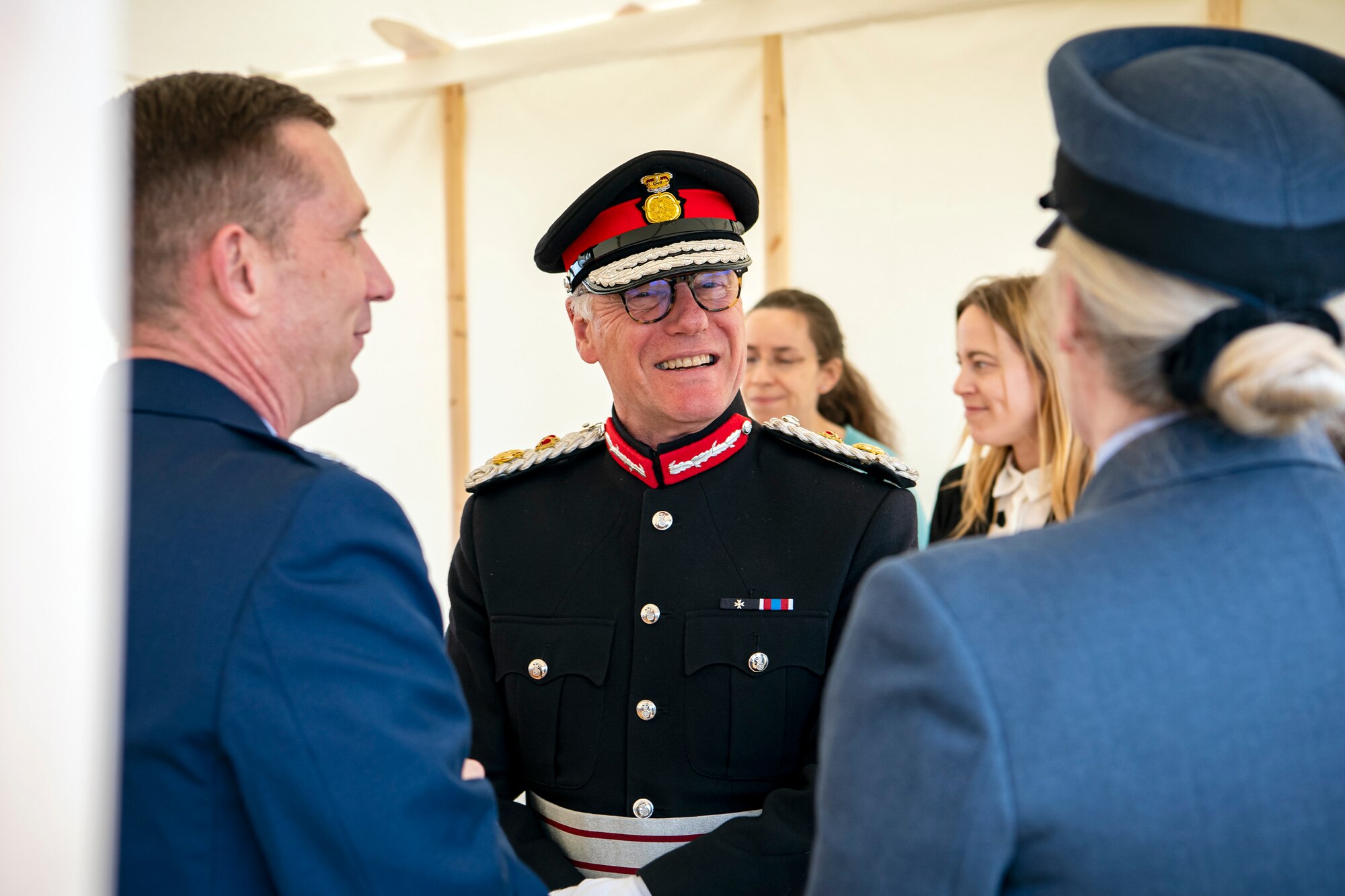 James Saunders-Watson, center, Lord-Lieutenant of Northamptonshire, speaks with U.S. Air Force Col. Jon T. Hannah, left, 422d Air Base Group commander, and Squadron Leader Jayne Robertson, right, RAF Croughton RAF commander, prior to the Queen’s Green Canopy event at RAF Croughton, England, April 13, 2022. The event celebrated the Queen’s Platinum Jubilee initiative, marking the 70th year of her reign. During the event, trees were planted to create a legacy in honor of the queen’s leadership of the nation. (U.S. Air Force photo by Staff Sgt. Eugene Oliver)