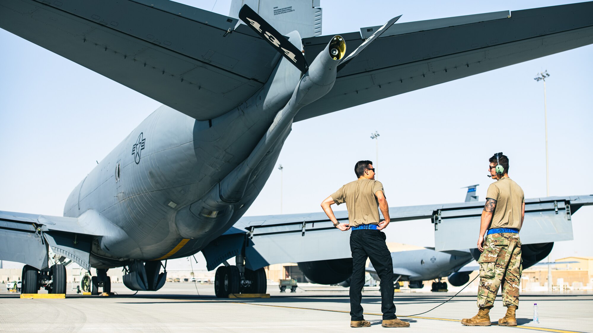 Airmen talk to each other on the flightline.