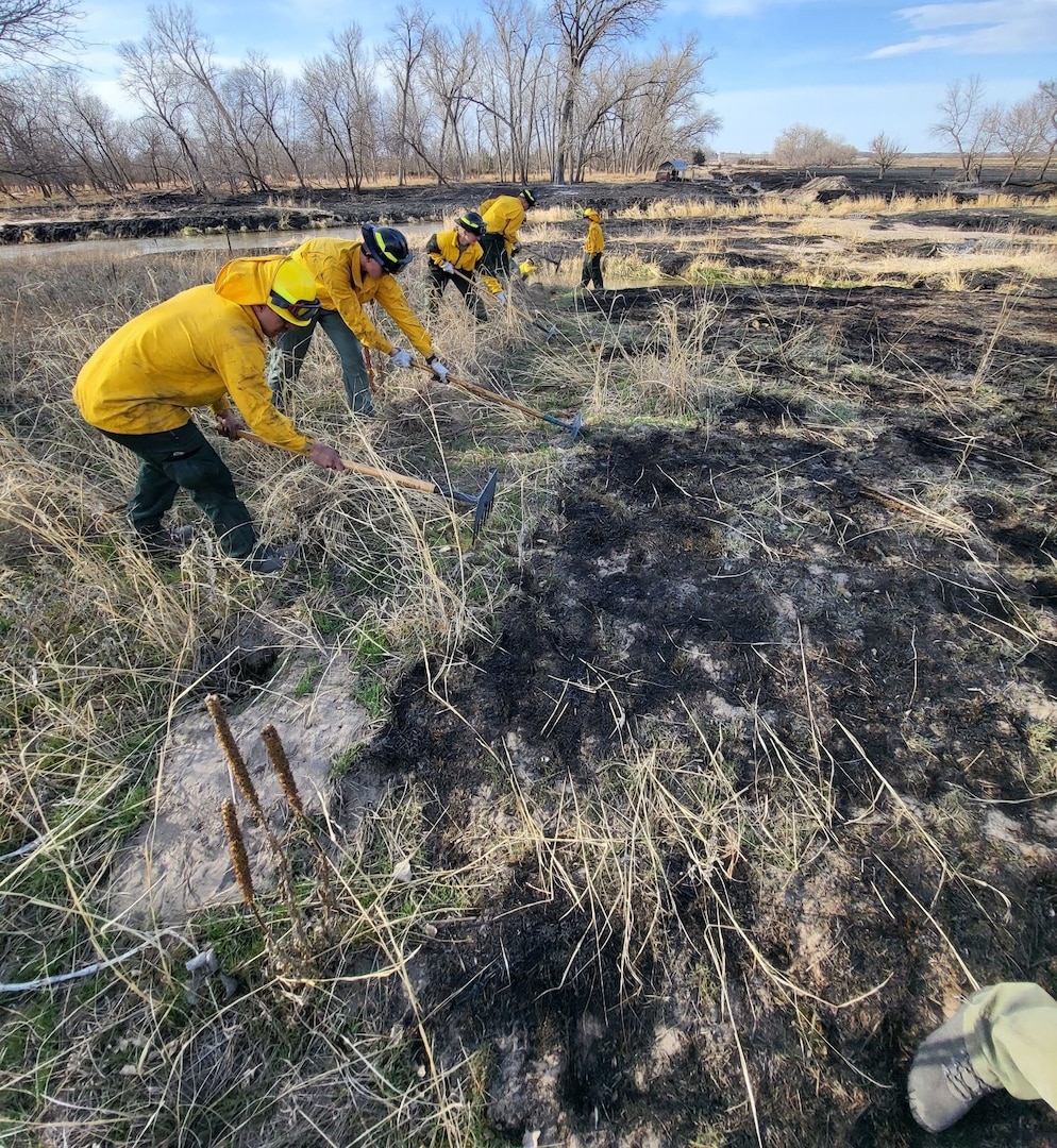 Airmen from the Nebraska Air National Guard's 155th Air Refueling Wing fire department establish a fire break to prevent wildfire spread near Arapahoe, Neb., April 11, 2022. High wind and drought fueled a fire that burned more than 30,000 acres and destroyed or damaged dozens of homes and other structures in Gosper and Furnas counties in south central Nebraska.