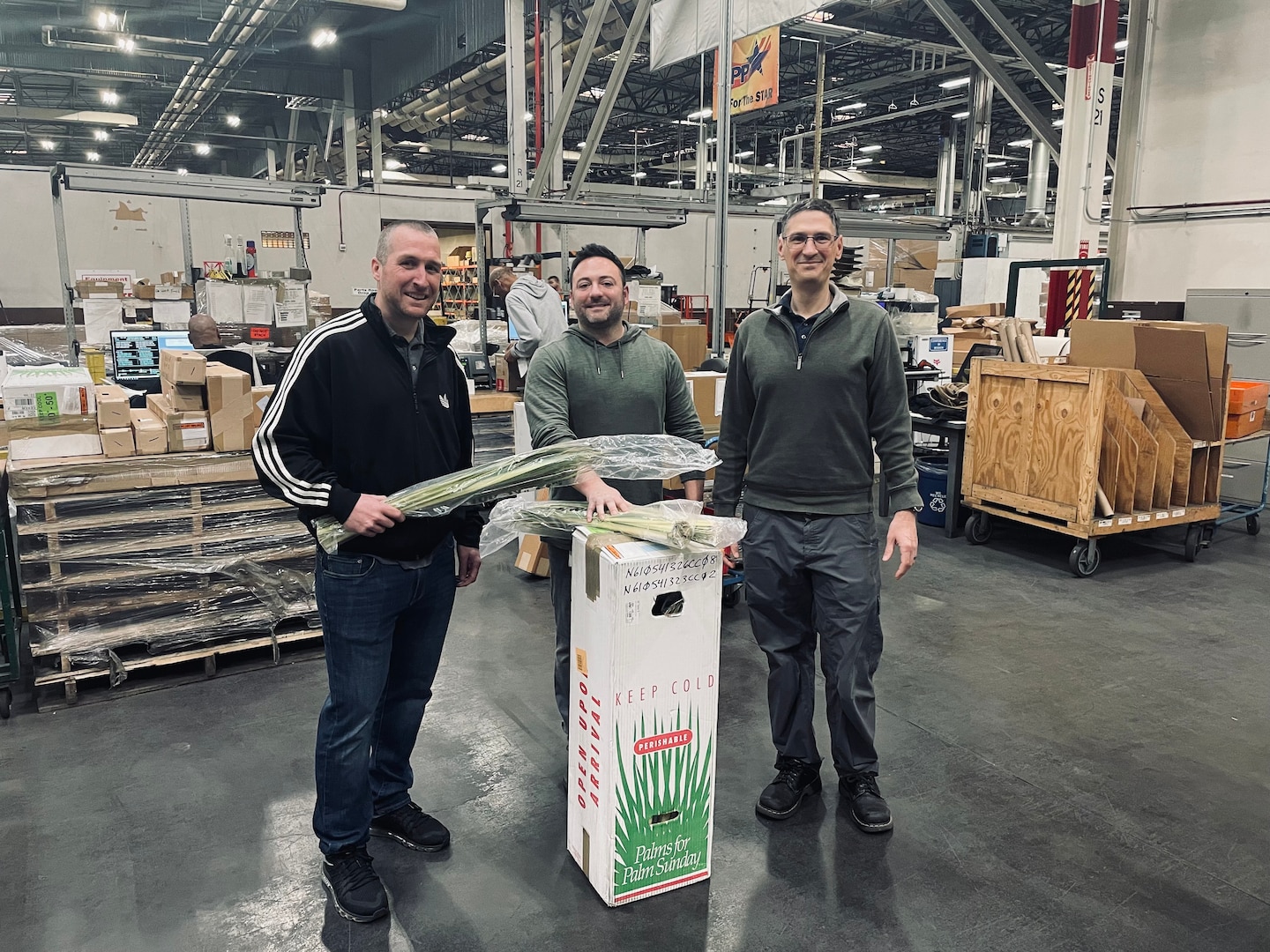 DLA employees pose with holy palms