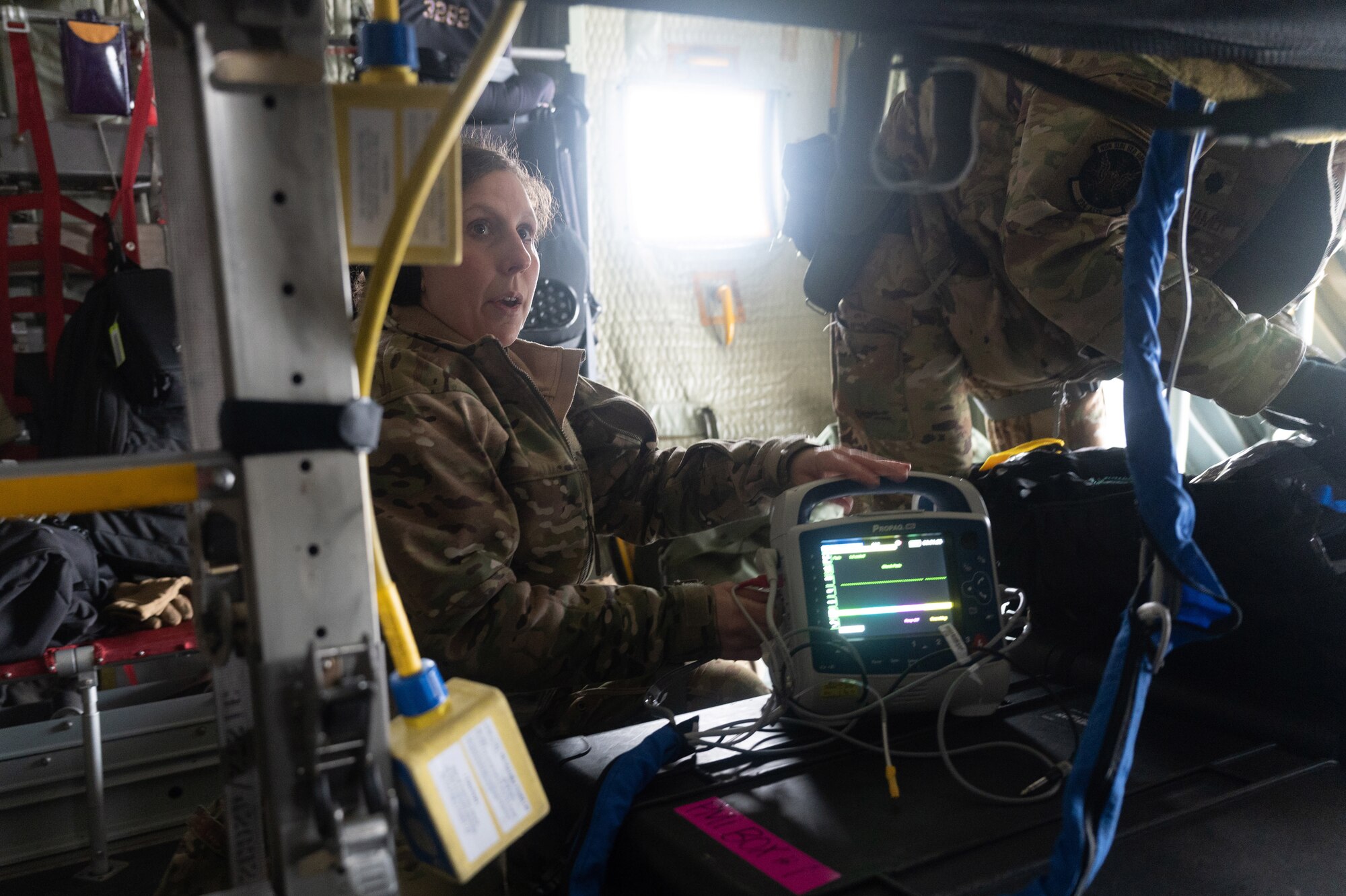 Maj. Christina Pesonen, a 934th Critical Care Air Transportation Team nurse practitioner, checks subjects vitals during exercise Viking Shield, at Volk Field Air National Guard Base, Wis., April 7, 2022. Viking Shield is a 934th Airlift Wing led exercise designed to strengthen training in a degraded environment. (U.S. Air Force photo by Airman 1st Class Colten Tessness)